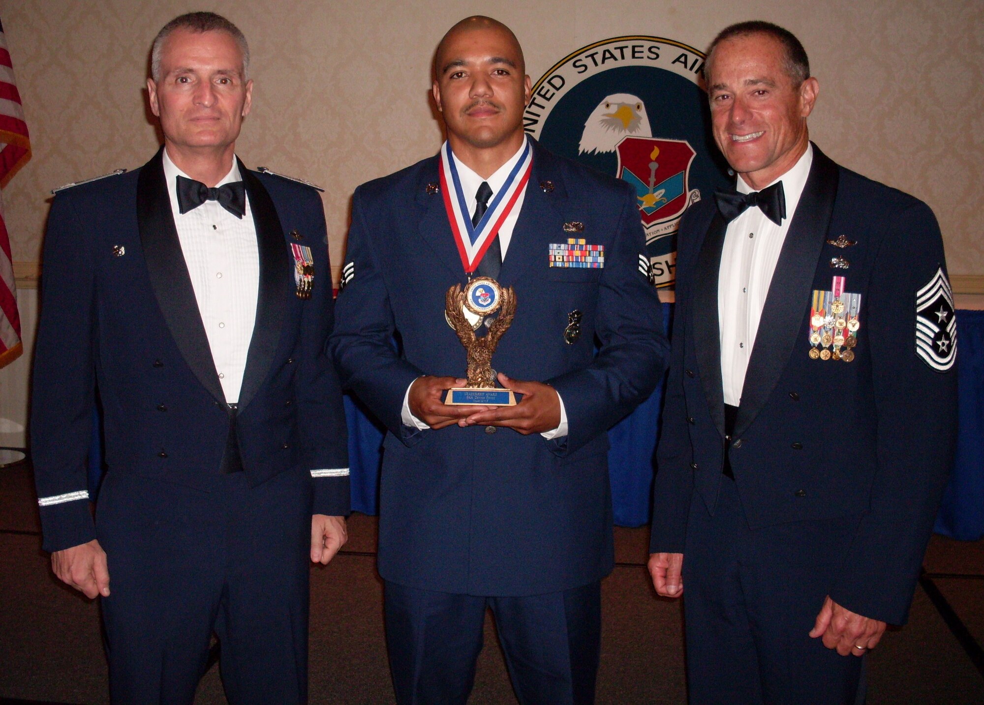 Senior Airman Dennis Pettit enjoys a photo opportunity with Col. Steven J. Chapman and Chief Master Sgt. Benson S. Futrell after capturing the Airman Leadership School Leadership Award during the graduation ceremony Aug. 12, 2010, at Charleston Air Force Base, S.C. Airman Pettit is a patrolman with the 315th Security Forces Squadron, Colonel Chapman is the commander of the 315 AW, and Chief Futrell is the 315 AW command chief master sergeant. (U.S. Air Force photo/Chief Master Sgt. James M. Snelgrove) 