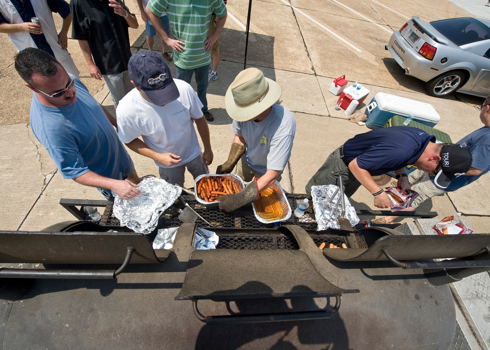 BARKSDALE AIR FORCE BASE, La. -- Volunteers grill food during a celebration cook out at Hoban Hall Aug. 13. The cook out was held to commemorate the one year anniversary of Air Force Global Strike Command. (U.S. Air Force photo by Senior Airman Chad Warren)(RELEASED)