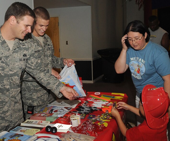 BARKSDALE AIR FORCE BASE, La. -- Barksdale Firefighters hand out large goodie bags about fire safety to families at a celebration cook out celebrating the first year anniversary of Air Force Global Strike Command Aug. 13 at Hoban Hall. Participants enjoyed food and live music and were joined by crime dog Scruff McGruff and Sparky the fire dog. (U.S. Air Force photo/Senior Airman Amber Ashcraft) (RELEASED)