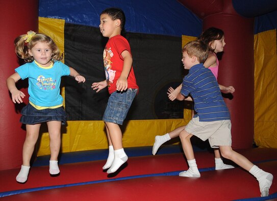 BARKSDALE AIR FORCE BASE, La. -- Children jump around in the bounce house at a celebration cook out celebrating the first year anniversary of Air Force Global Strike Command Aug. 13 at Hoban Hall. Participants enjoyed food and live music and were joined by crime dog Scruff McGruff and Sparky the fire dog. (U.S. Air Force photo/Senior Airman Amber Ashcraft) (RELEASED)