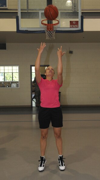BARKSDALE AIR FORCE BASE, La. -- Capt. Melissa Riddick, Air Force Global Strike Command sustainment and community branch chief, performs a trick shot to be duplicated by her opponent during the basketball game 'HORSE' Aug. 13 at the fitness center. Instead of using the letters from 'horse', participants kept score by using 'AFGSC' in honor of the Air Force Global Strike Command's first year anniversary. (U.S. Air Force photo/Senior Airman Amber Ashcraft) (RELEASED)