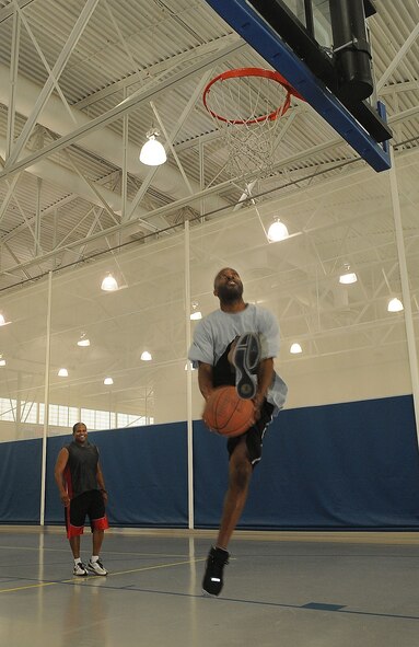 BARKSDALE AIR FORCE BASE, La. -- Staff Sgt. Louis Haney, Air Force Global Strike Command Public Affairs, performs a trick shot to be duplicated by his opponent during the basketball game 'HORSE' Aug. 13 at the fitness center. Instead of using the letters from 'horse', participants kept score by using 'AFGSC' in honor of the Air Force Global Strike Command's first year anniversary. (U.S. Air Force photo/Senior Airman Amber Ashcraft) (RELEASED)