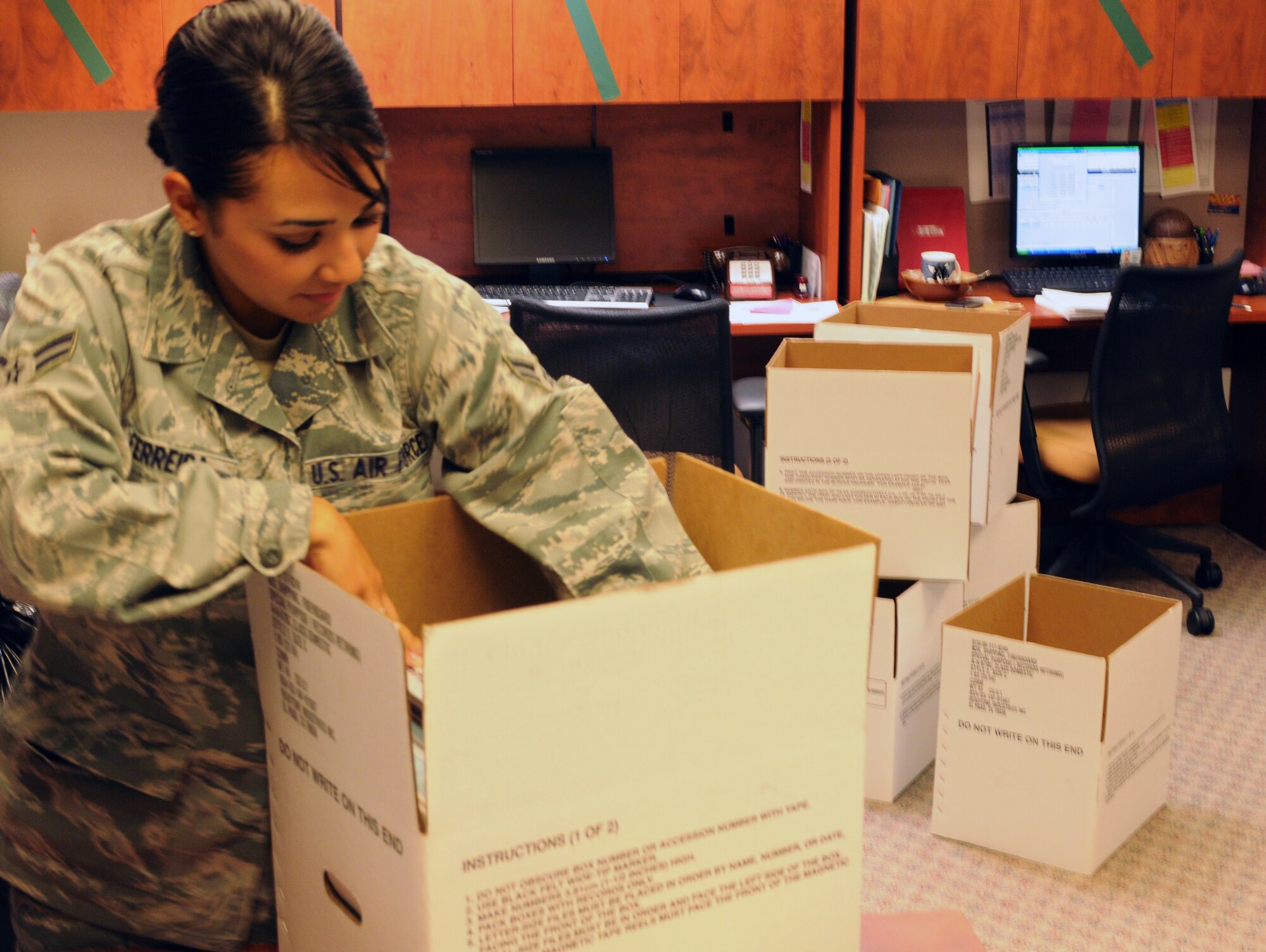 In preparation for the remodeling of building 44, Airman 1st Class Vanessa Ferreria, aviation resource manager, packs her office Aug. 8 to move near building 40, also known as the Bell Building. The remodeling is scheduled to take 18 to 24 months during which time Operations Group and 152nd Fighter Squadron personnel will function primarily from trailers. (Air Force photo by Staff Sgt. Jordan Jones)