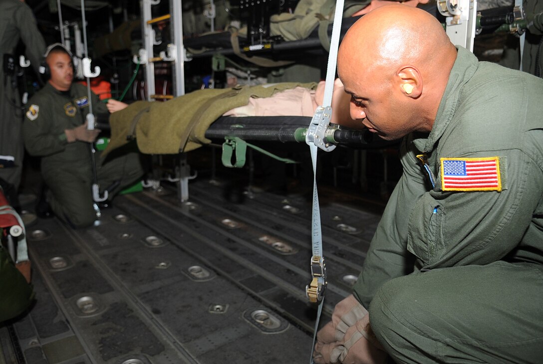 Senior Master Sgt. Rodney Lindsey, 375th Aeromedical Evacuation Squadron superintendent, secures a training manikin patient in preparation for takeoff from Scott Air Force Base, Il., 12 August 2010.  SMSgt Lindsey along with other members of the aeromedical evacuation team showed members of a congressional delegation the set up and equipment used to evacuate wounded warriors from deployed locations around the globe.  (U.S. Air Force photo by Senior Airman Melissa V. Brownstein)