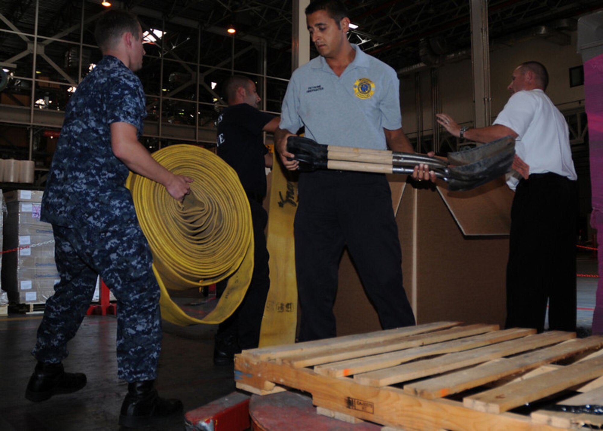 NAPLES, Italy -- Logistic Specialist 2nd Class(SW) Vitali Toptchenko, NSA Naples Lead Fire Inspector Hanz Christian, and Italian national firefighters Maurazio Patrone and Alessio Storto load a pallet of firefighting equipment destined for Russia to help combat wildfires Aug. 11, 2010. The U.S. Navy routinely provides foreign humanitarian assistance in times of crisis, in the same manner as many nations around the world. (U.S. Navy photo by Mass Communication Specialist 3rd Class Kristopher Regan)