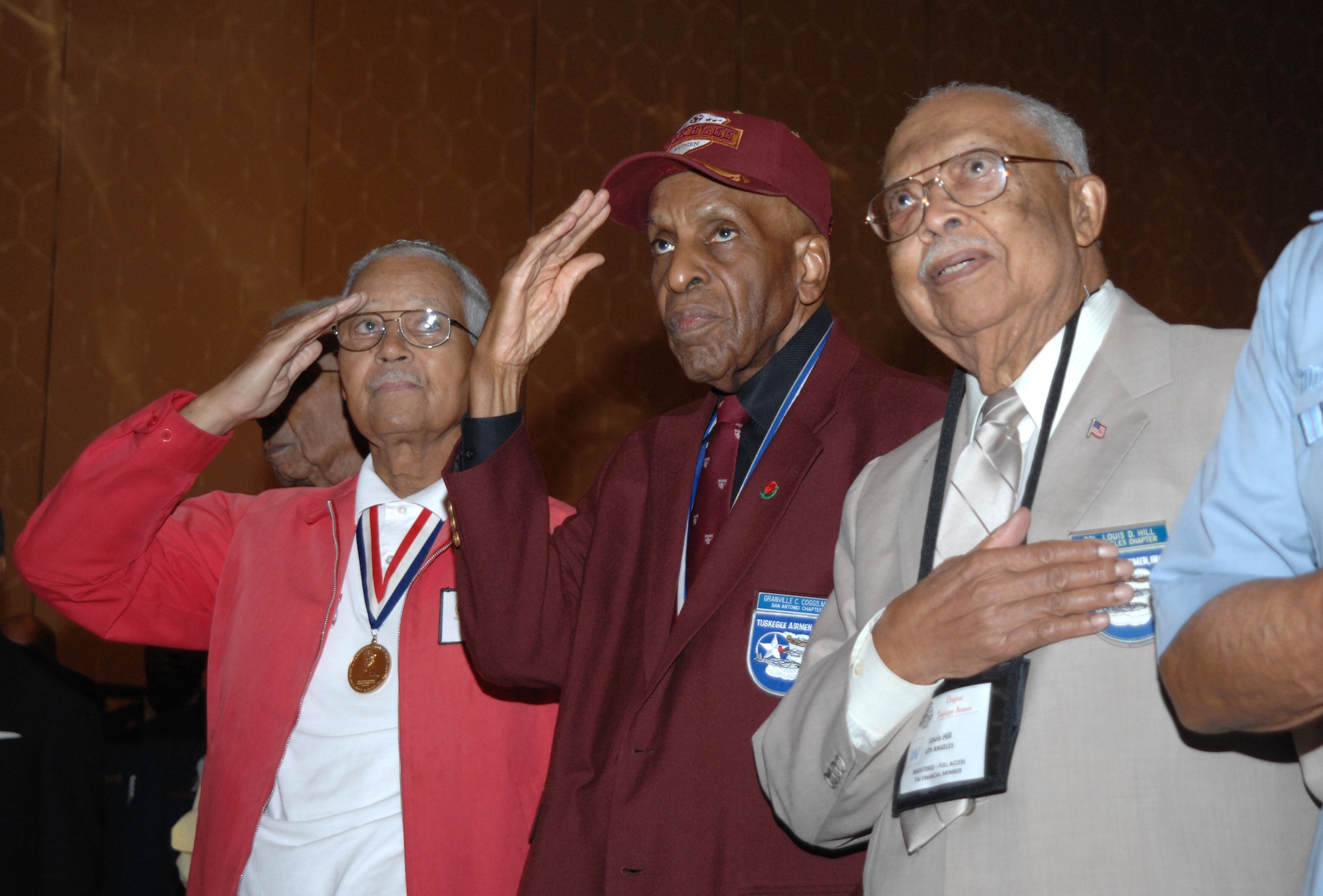 Members of Tuskegee Airmen, Inc., pay their respect as Taps is sung during the Lonely Eagles Ceremony to honor fallen service members at the Tuskegee Airmen Incorporated, 39th Annual Convention in San Antonio, Texas, on July 29, 2010.(USAF photo by Senior Master Sergeant Kim Allain)(released)