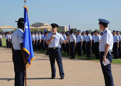 Gen. Stephen Lorenz (right), AETC commander and Chief Master Sgt. Robert Tappana (left), AETC command chief, speak to audience members and trainees during basic military training graduation at Lackland AFB, Texas Aug. 13.  This was chief’s last ceremony and speech as he retired Aug 13 at Randolph AFB, TX. (U.S. Air Force photo/Alan Boedeker)