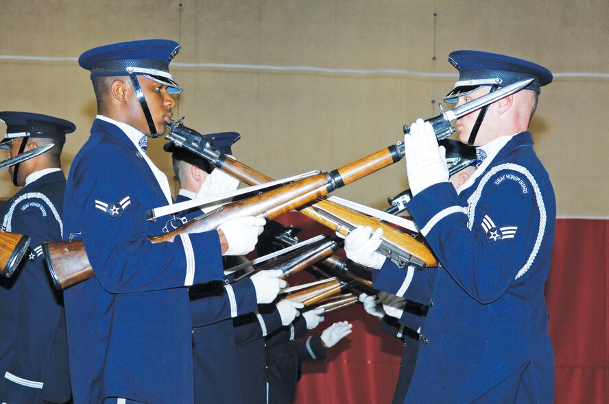 Airman 1st Class Doyle Boyd and Senior Airman Derrick Sullivan, from the Air Force Honor Guard Drill Team, execute a weapons exchange during the performance held on August 10 in the Luke Youth Center, Luke Air Force Base, Arizona.  (U.S. Air Force photo/Staff Sgt. Steve Nabor)