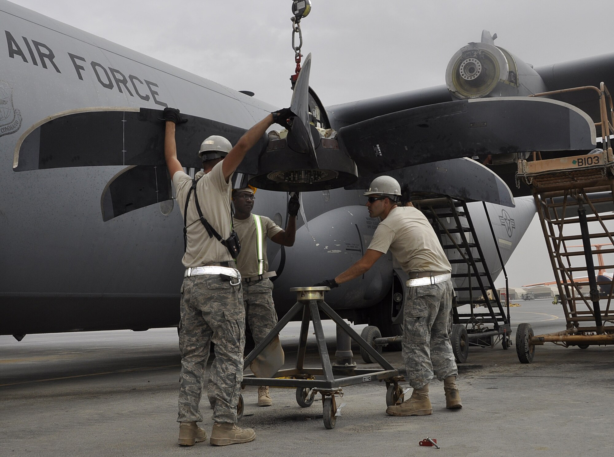 Members of the 451st Expeditionary Aircraft Maintenance Squadron remove a damaged propeller from a C-130J Hercules aircraft Aug. 8, 2010.  (U.S. Air Force photo by Tech Sgt. Renni Thornton/Released)  