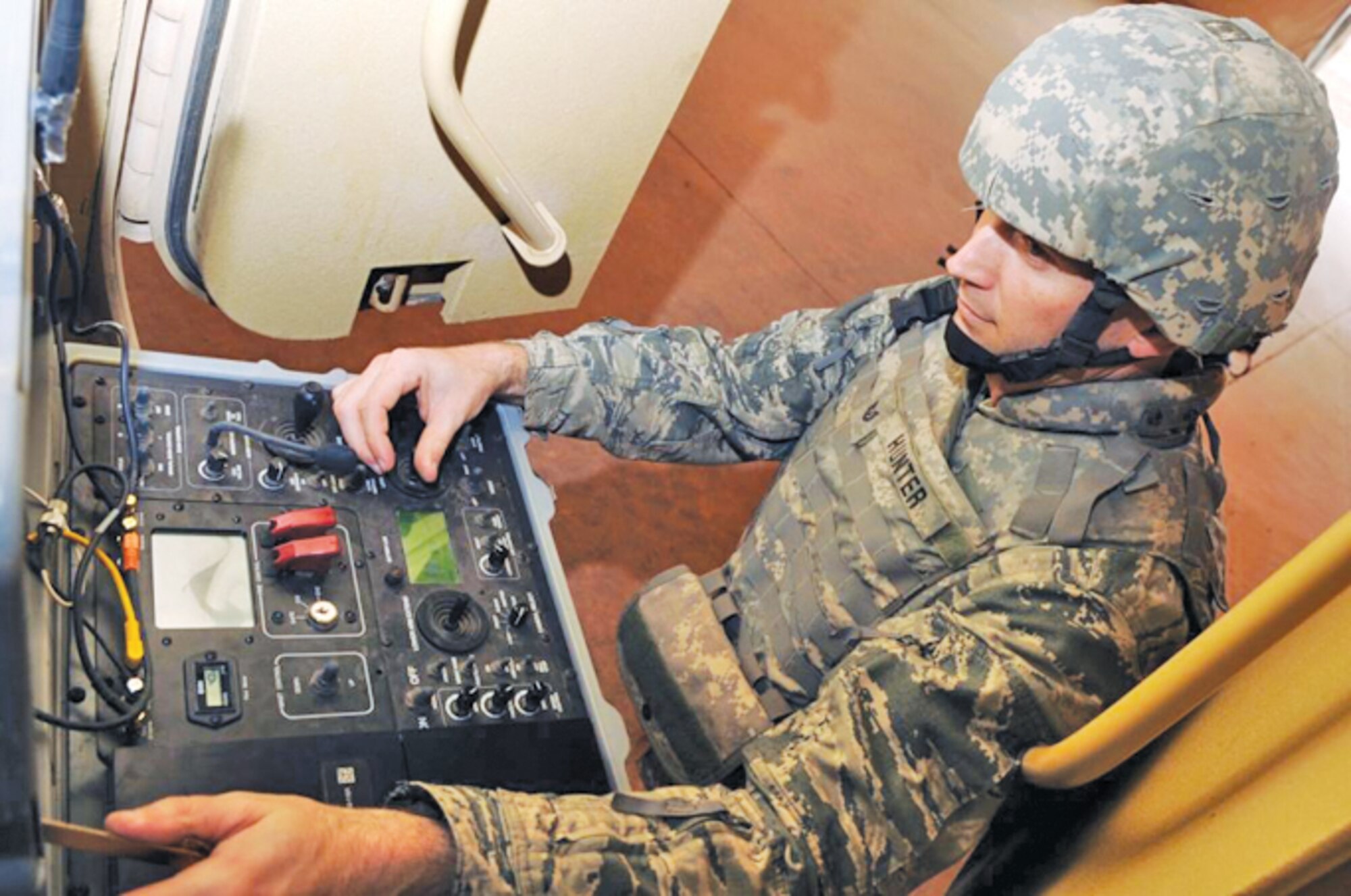 Tech. Sgt. Stephen Hunter, 944th Civil Engineer Squadron explosive ordnance disposal technician, operates the controls of a Talon robot while deployed to Joint Base Balad, Iraq.   Sergeant Hunter was recently named as one of the 12 Outstanding Airmen of the Year for 2010.  (Courtesy photo)