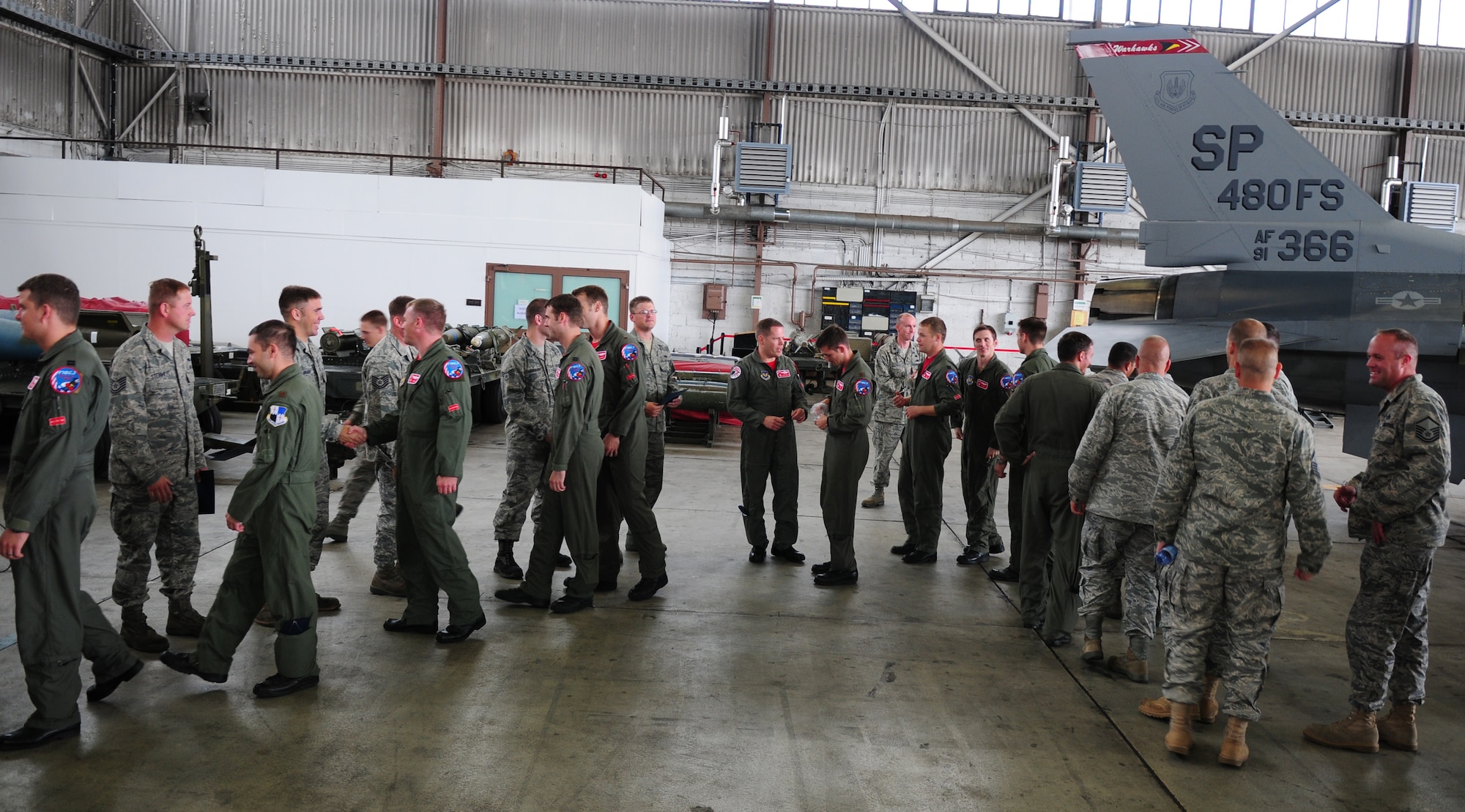 SPANGDAHLEM AIR BASE, Germany – Pilots, spectators and all in attendance at the Dedicated Crew Chief Ceremony form a line congratulating the twenty-nine F-16 Fighting Falcon crew chiefs on their assignments to specific aircraft in the 480th Fighter Squadron fleet Aug 13. This ceremony followed the activation of the 480th Fighter Squadron here earlier that day. (U.S. Air Force Photo by/Staff Sgt. Heather M. Norris)