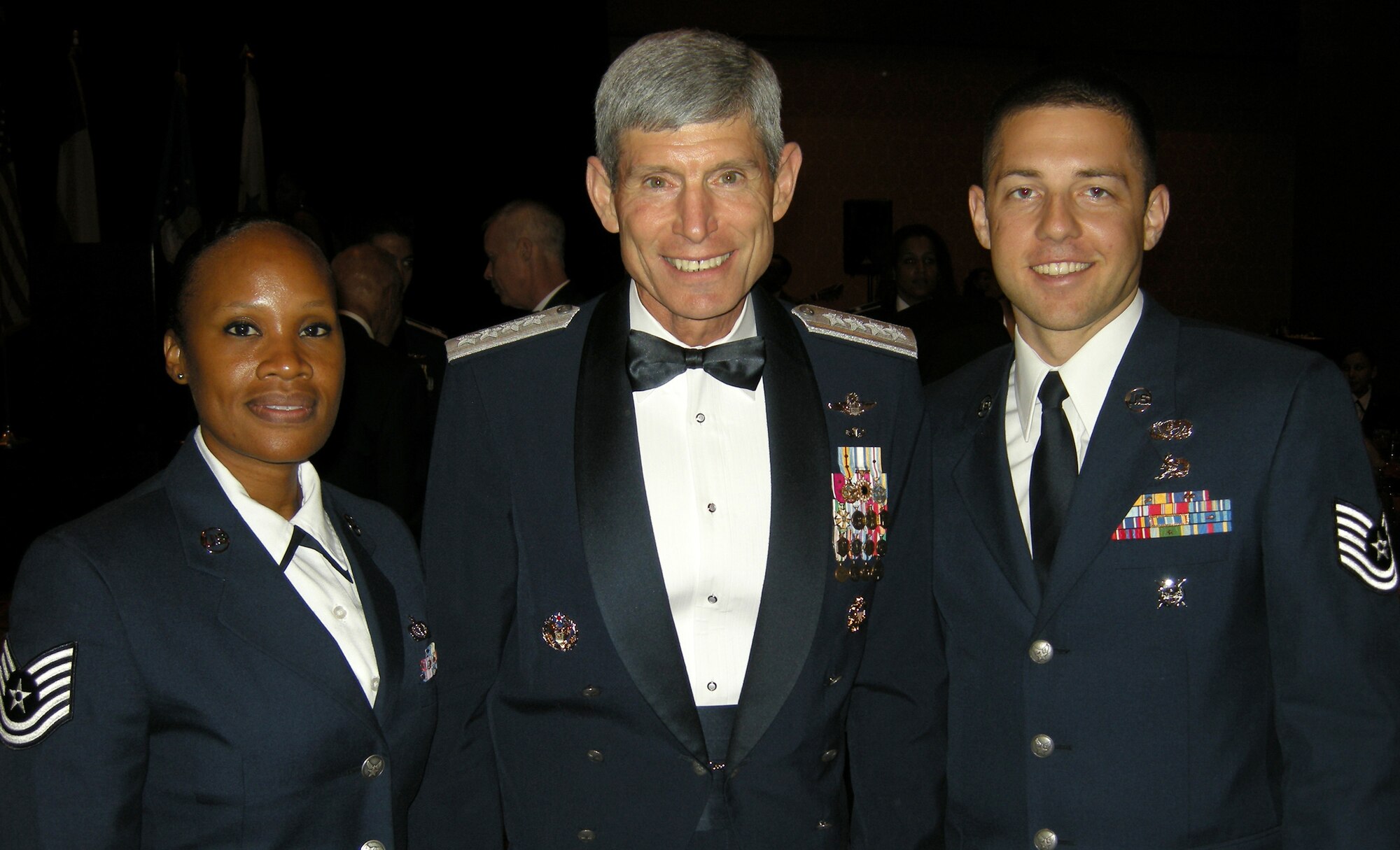 Tech. Sgts. Hope Clark-Vasquez and Christopher Whigham (right) pose with Air Force Chief of Staff Gen. Norton Schwartz July 29 during festivities at the 39th Annual Tuskegee Airmen National Convention in San Antonio. Eight Airmen from the Air Force Reserve's 302nd Airlift Wing attended the event, hearing from senior military leaders on topics including mentoring, women in the military and financial management as well as training on leadership and development. The 302nd AW members also took part in sit-down conversations with surviving members of the famed Tuskegee Airmen "Red Tails" as they described their experiences from World War II and the military in general to the AF Reservists. The conference attendance was part of a series of career broadening events sponsored by the 302nd AW's Human Resources Development Council. (Courtesy photo)