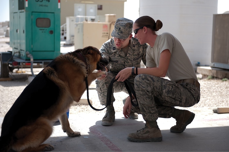 Chaplain (Capt.) Mark Juchter, assigned to the 379th Air Expeditionary Wing during a deployment last year in Southwest Asia, visits Senior Airman Carrie Dowdy, a military working dog handler with the 379th Expeditionary Security Forces Squadron. Chaplain Juchter held the weekly traditional Protestant service and visited Airmen around the base. (Air Force photo by Staff Sgt. Robert Barney)
