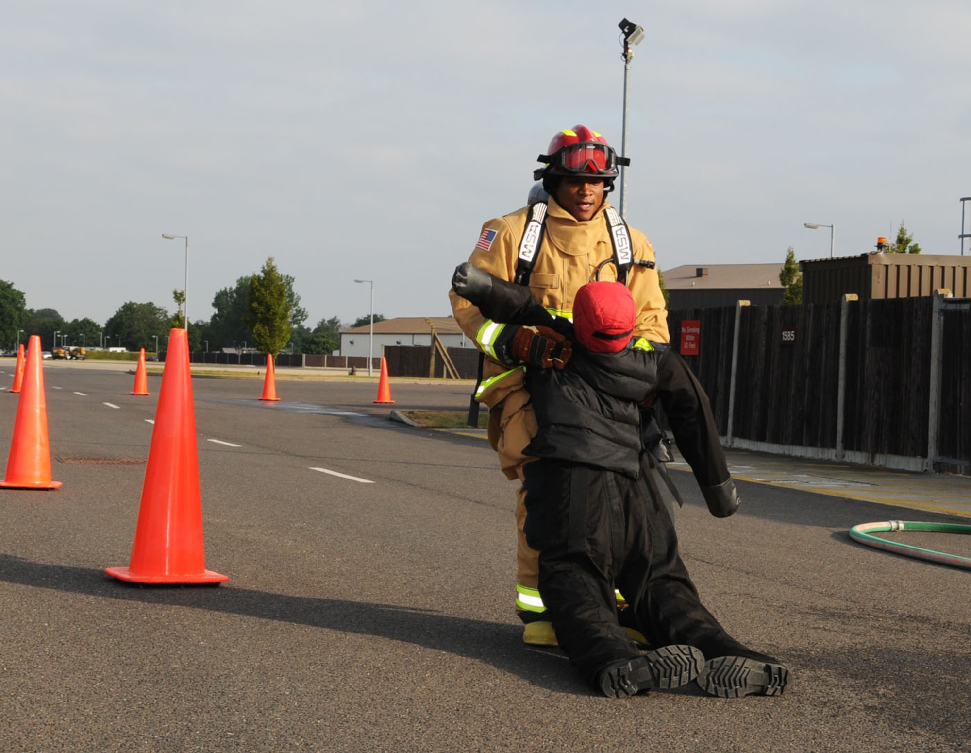 Tech. Sgt. Corey Coleman, 100th Civil Engineer Squadron Fire Department, drags a 175-pound mannequin as part of the training session for the firefighter challenge. A team of six firefighters from RAF Mildenhall will be participating in the Firefighter Combat Challenge World Challenge XIX in November in South Carolina. The competition has approximately 1,000 competitors, with more than 120 teams participating, most of which are from civilian fire departments. All tasks within the contest have to be done wearing full protective gear, including breathing apparatus and mask. (U.S. Air Force photo/Karen Abeyasekere)