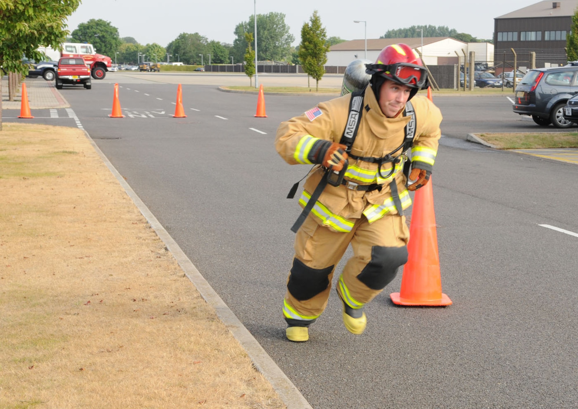 Tech. Sgt. Adam Crowe, 100th Civil Engineer Squadron Fire Department, runs down to a marker before zig-zagging through cones and finally picking up a 175-pound mannequin, which he then drags backwards 100-feet across the finish line. Sergeant Crowe is one of a six-man team from RAF Mildenhall participating in this year's Firefighter Combat Challenge World Challenge XIX in November. The firefighters train on a variety of tasks, including running the stairs of the air traffic control tower with a hose pack on their shoulder, and knocking a 160-pound metal sled backwards 5 feet. (U.S. Air Force photo/Karen Abeyasekere)