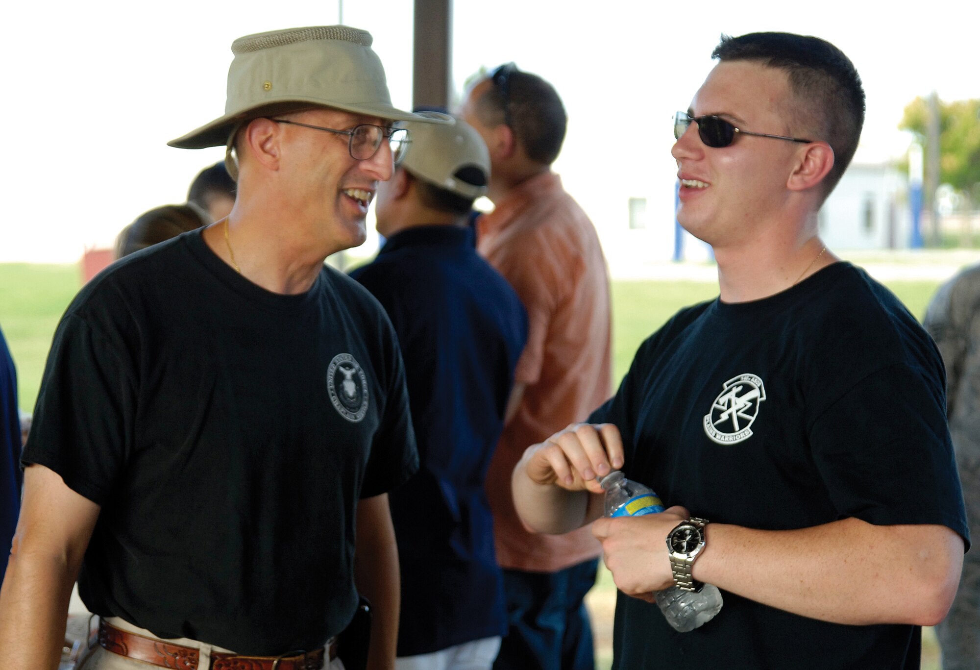 During a recent steak cookout at the Latte’ Lounge in the dorm area, chapel volunteers and staff cooked and served and visited with residents.  Wing Chaplain (Lt. Col.) David Terrinoni, talks with Airman 1st Class Chris Rowland, a family practice medic in the 72nd Medical Group. (Air Force photo by Margo Wright)
