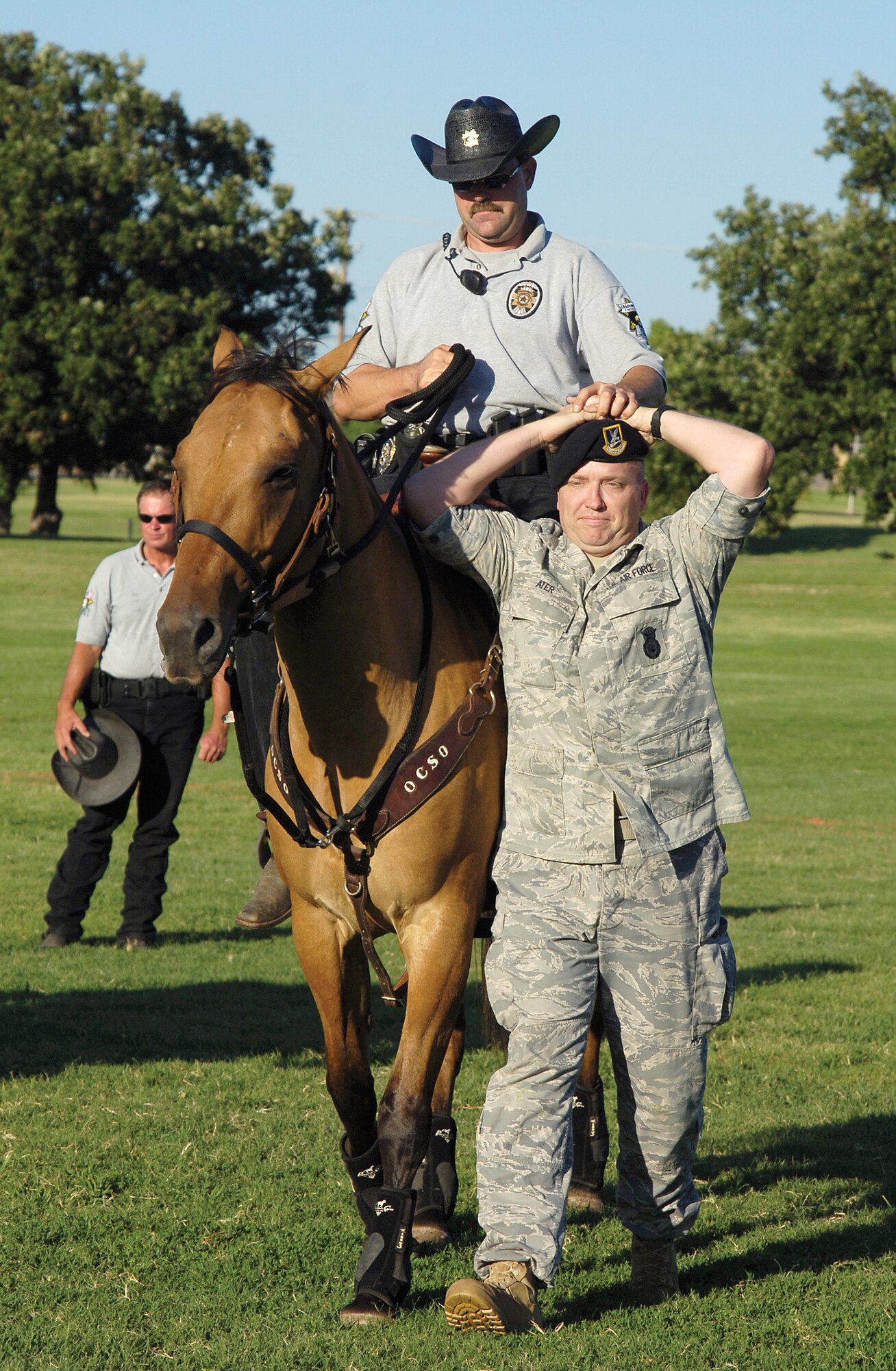 Base and local fire protection, emergency services and law enforcement welcomed Tinker residents to a National Night Out celebration Aug. 3 on base. Oklahoma County deputy sheriffs demonstrated how a mounted patrol can work within a crowd and manage any rowdy situation when needed. Volunteering as a “bad guy” was 72nd Security Forces Squadron Tech. Sgt. John Ater, a trainer/supervisor in the military working dog section. (Air Force photos by Margo Wright)
