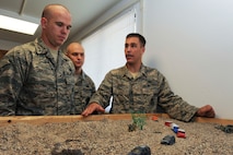 MINOT AIR FORCE BASE, N.D. -- Staff Sgt. Ryan Pfeifer, 791st Missile Security Forces Squadron convoy response force leader, explains a recovery and recapture exercise using a visual aid to Senior Airmans Barrett Curlis and Ian Schwartz, both 791st MSFS convoy response force leaders,  here Aug. 12.  Sergeant Pfeifer was recently named one of the Air Force’s 12 Outstanding Airmen of the year. (U.S. Air Force photo by Tech. Sgt. Lee A. Osberry Jr.)