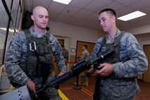 MINOT AIR FORCE BASE, N.D. -- Staff Sgt. Ryan Pfeifer, 791st Missile Security Forces Squadron convoy response force leader, clears his M-4 carbine rifle while Senior Airman Ian Schwartz, 791st MSFS convoy response force leader, ensures safety prior to a convoy training mission here Aug. 12. Sergeant Pfeifer was recently named one of the Air Force’s 12 Outstanding Airmen of the year. (U.S. Air Force photo by Tech. Sgt. Lee A. Osberry Jr.)