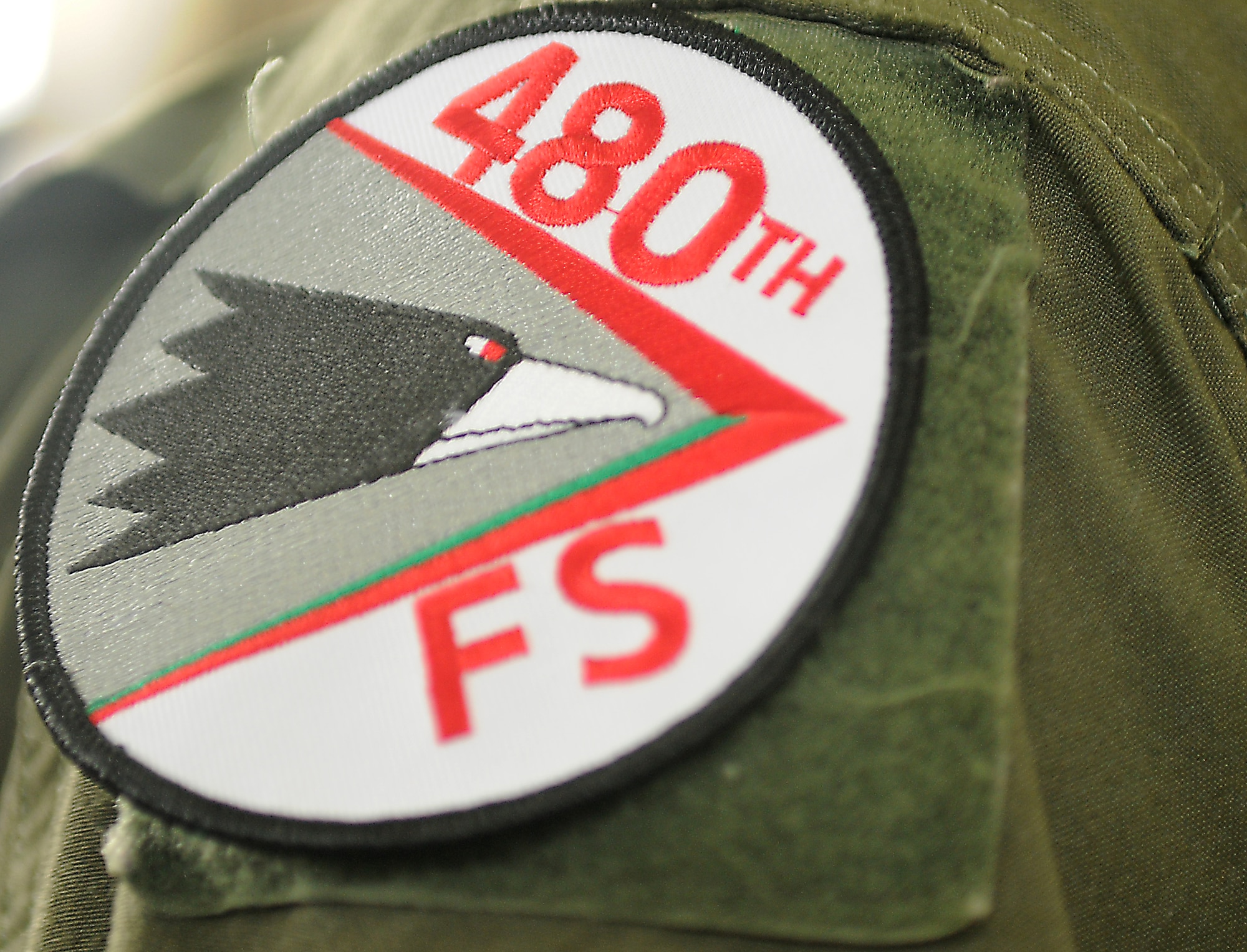 SPANGDAHLEM AIR BASE, Germany--The 480th Fighter Squadron patch is visible on the arm of an F-16 Fighting Falcon pilot during the 480th’s activation ceremony Aug. 13.  During the ceremony all 22nd Fighter Squadron “Stingers” removed their patches and replaced them with new Warhawk patch.  The 480th is Spangdahlem’s newest F-16 Fighting Falcon squadron, and took on the motto “From Escardrille to Warhawks” to signify its geographical ties to the Lafayette Escadrille in France. Prior to America’s entry into World War I, 38 American pilots volunteered to fly for the French Aéronautique militaire in April 1916 and are known as America’s first fighter aircraft aviators.  (U.S. Air Force photo/Staff Sgt. Logan Tuttle)