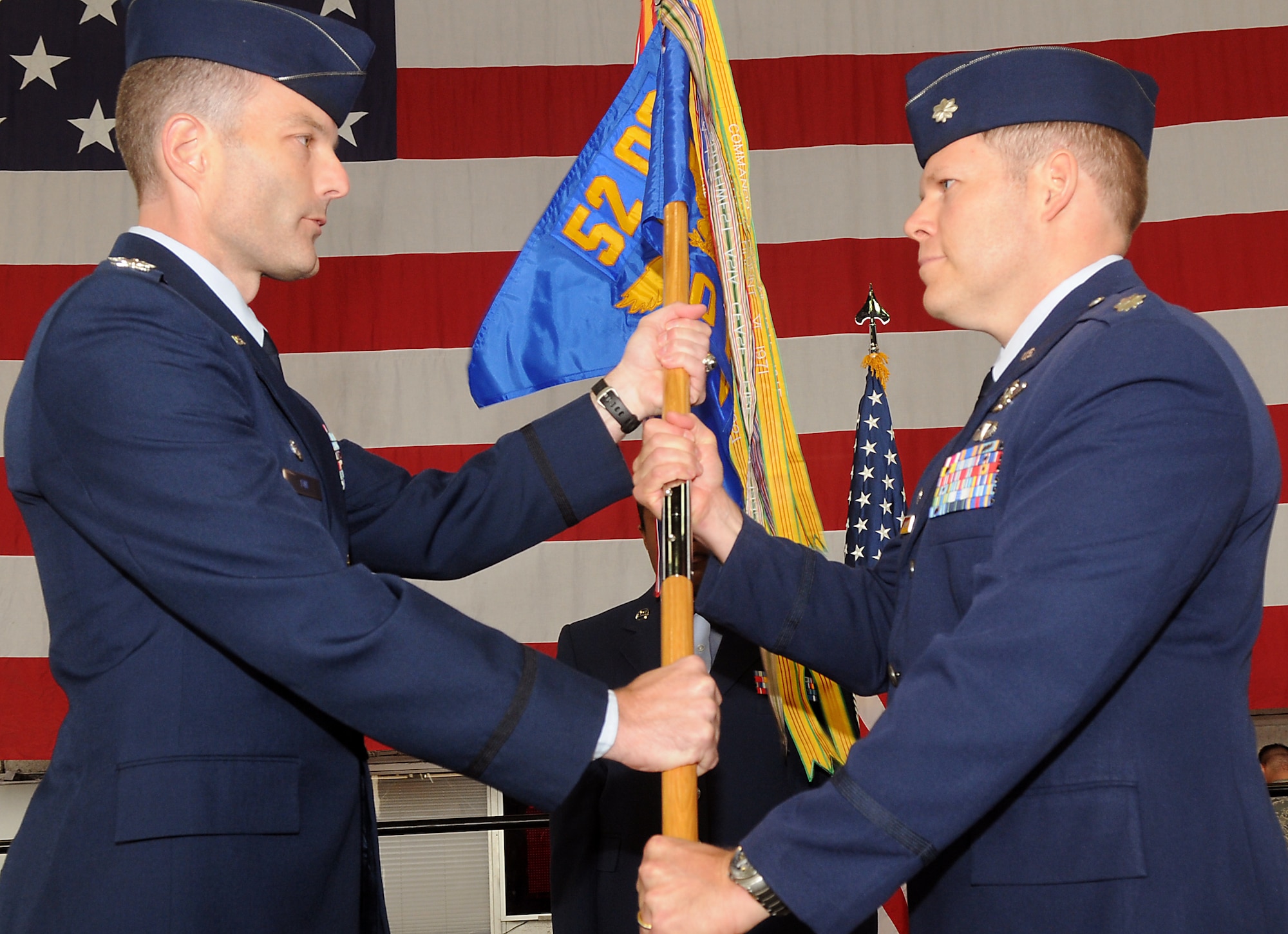 SPANGDAHLEM AIR BASE, Germany—Col. Jackson Fox, 52nd Operations Group commander presents the 480th Fighter Squadron guidon to Lt. Col. Andrew Wolcott, 480th FS commander, as he assumes command Aug. 13.  The 480th is Spangdahlem’s newest F-16 Fighting Falcon squadron, and took on the motto “From Escardrille to Warhawks” to signify its geographical ties to the Lafayette Escadrille in France. Prior to America’s entry into World War I, 38 American pilots volunteered to fly for the French Aéronautique militaire in April 1916 and are known as America’s first fighter aircraft aviators.  (U.S. Air Force photo/Staff Sgt. Logan Tuttle)