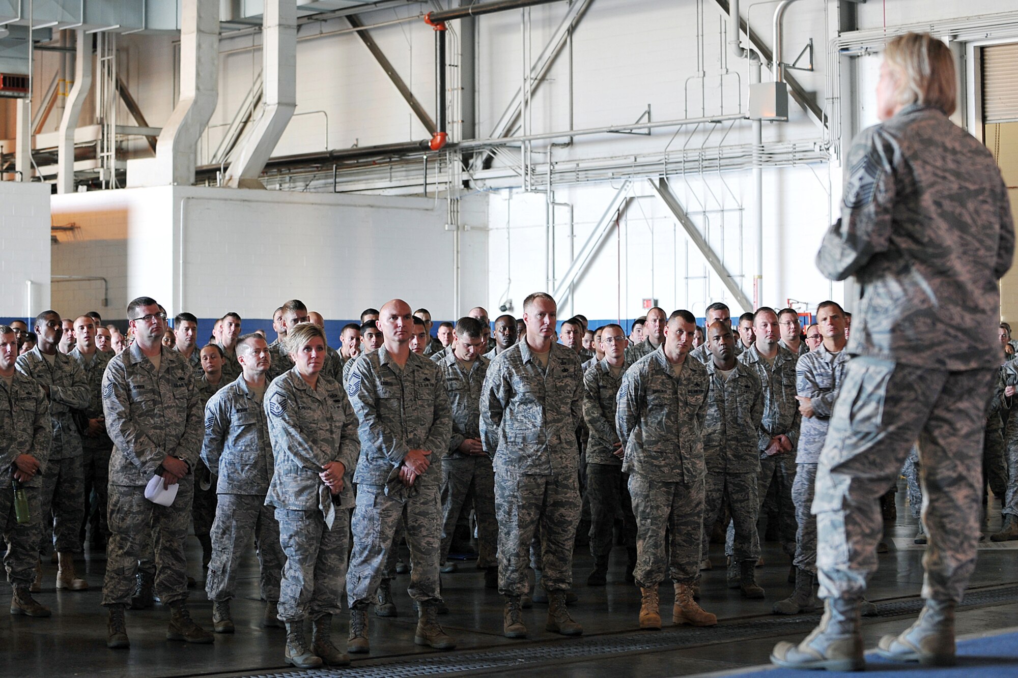 OFFUTT AIR FORCE BASE, Neb. - Team Offutt enlisted members listen to new 55th Wing Command Chief Master Sgt. Suzan Sangster during her first enlisted call here Aug. 11 inside the Bennie Davis Maintenance Facility. U.S. Air Force photo by Charles Haymond