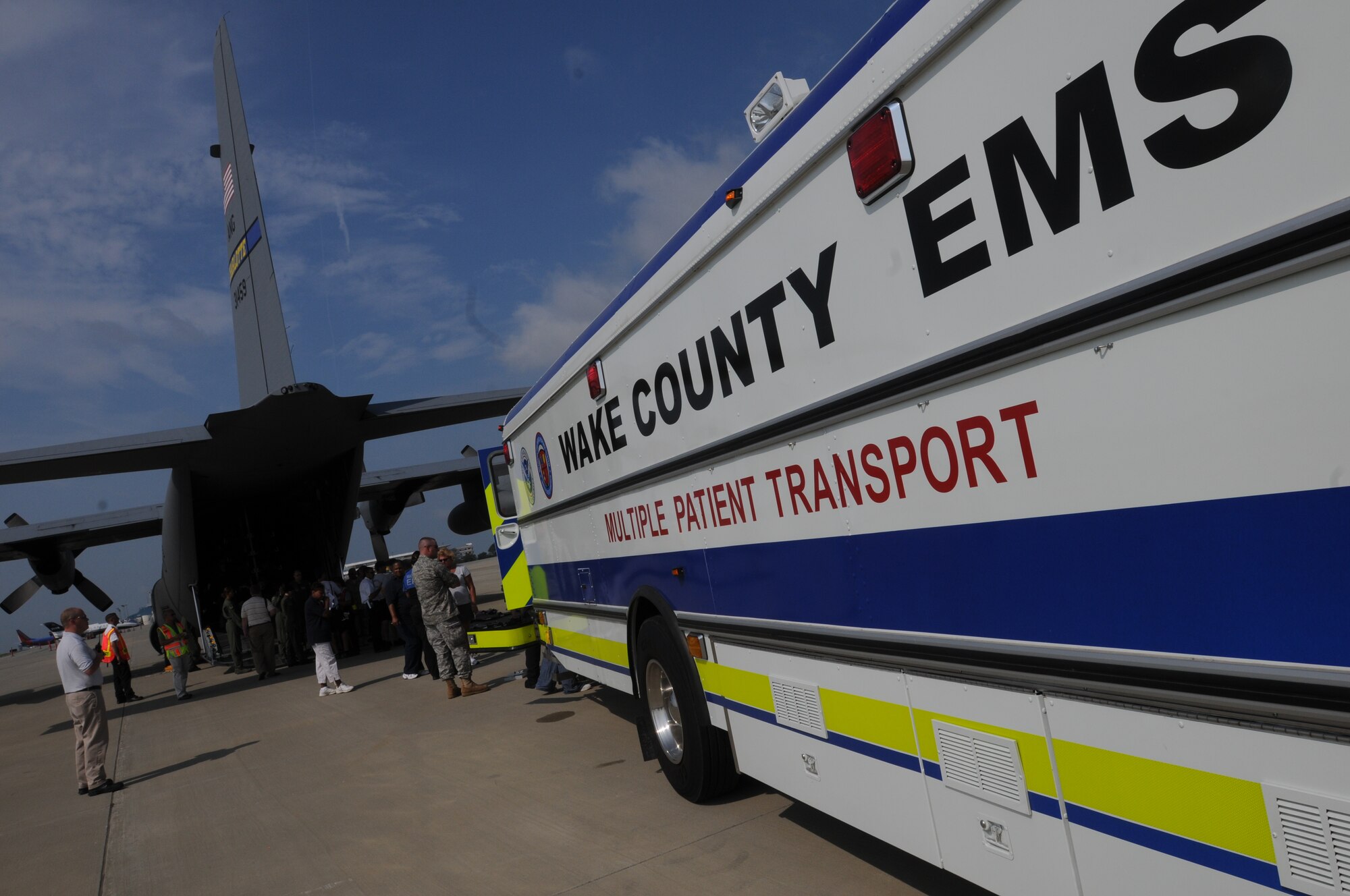 Cutline: Raleigh, N.C. --  During a National Emergency Excerise at the Raleigh Durham InternationalAiport, paitents are offloaded from a C-130 HErcules Cargo plane onto a Wake Country EMS Multiple Patient Transport bus. The156th Airlift Squadron will be assisting the Wake County Emergency Medical Distaster Response exercise at the Raleigh Durham International Airport. Both Airmen are assigned to the 156th Aeromedical Evacation Squadron, North Carolina Air National Guard. PAO Released. Photo by Tech. Sgt. Brian E. Christiansen, North Carolina Air National Guard. 156th AES Supports Wake County Exercise at RDU 