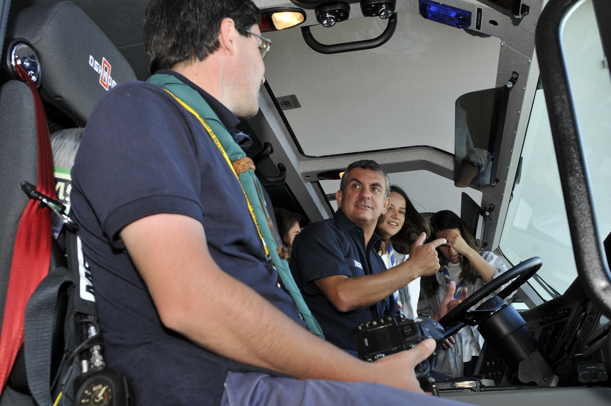 Valdemar Toste, a 65th Civil Engineer Squadron’s truck driver, explains the functions of a Striker 3000 truck to a combined Boy and Girls Scout troop from Lisbon during a visit to Lajes Field, Azores, Aug. 2. (U.S. Air Force photo/Staff Sgt. Olufemi Owolabi)