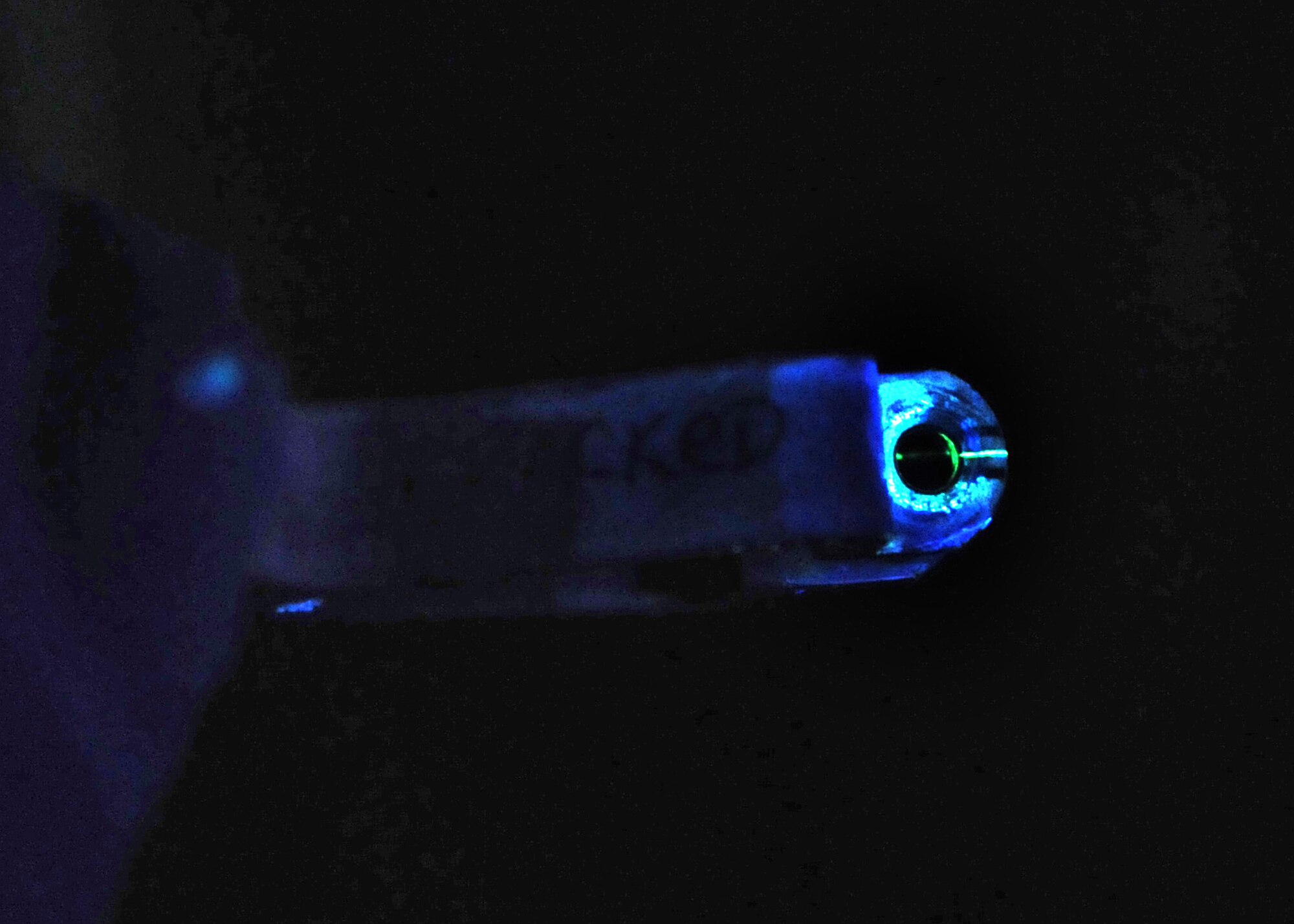 A black light shows a crack on an ejection handle after it has been processed through fluorescent penetrants. (U.S. Air Force photo/ Staff Sgt. Nadine Y. Barclay)