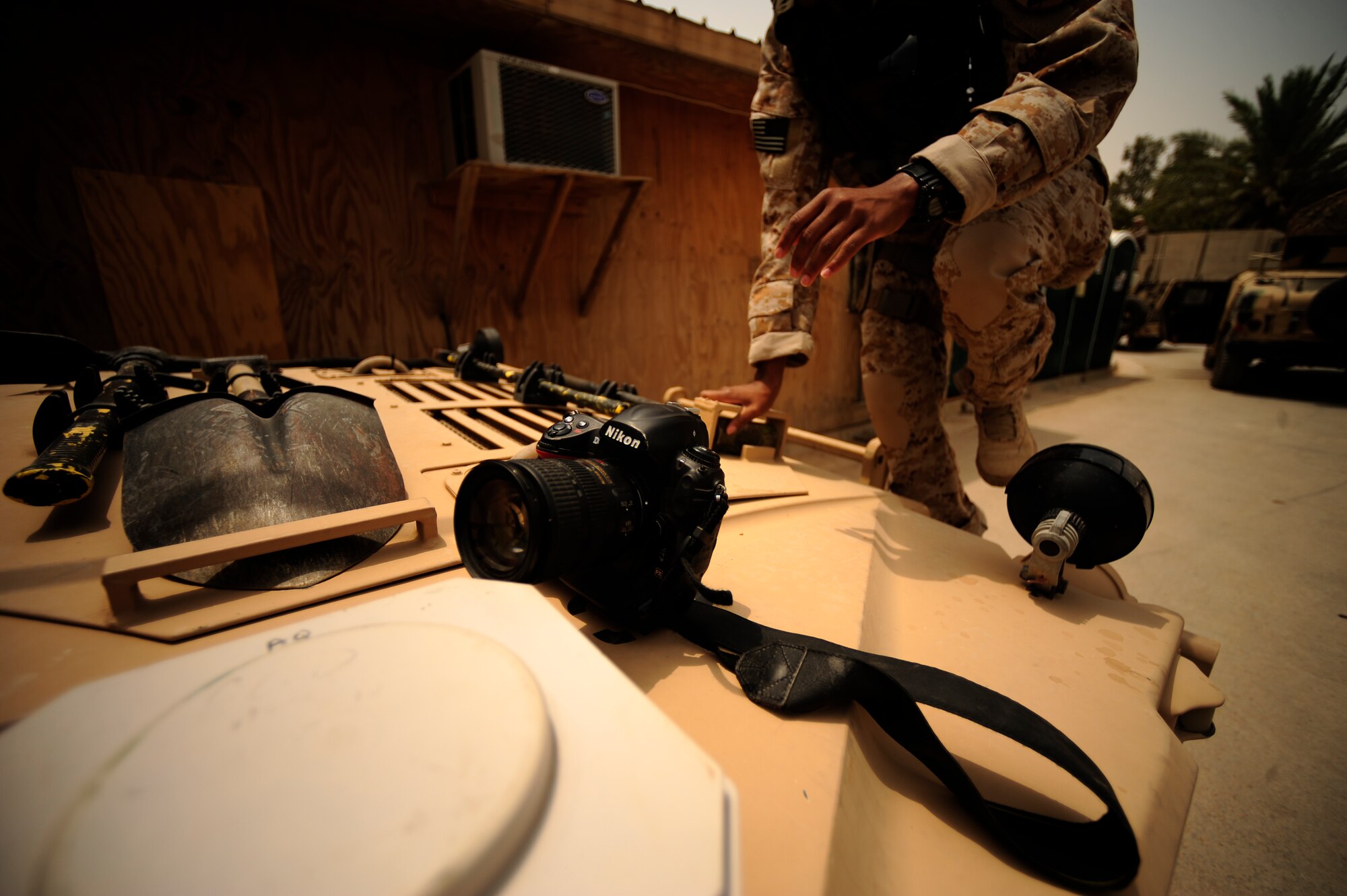 U.S. Air Force Senior Airman Asha McMakin, a combat photographer assigned to the 1st Combat Camera Squadron, climbs onto a High Mobility Multipurpose Wheeled Vehicle(HMMWV) while documenting team members prepping for key leader engagement mission at Ramadi, Iraq on Aug. 2, 2010. SrA McMakin is attached to an Army Civil Affairs team while deployed in support of Operation Iraqi Freedom.
(U.S. Air Force photo by Staff Sgt. Andy M. Kin / Released)