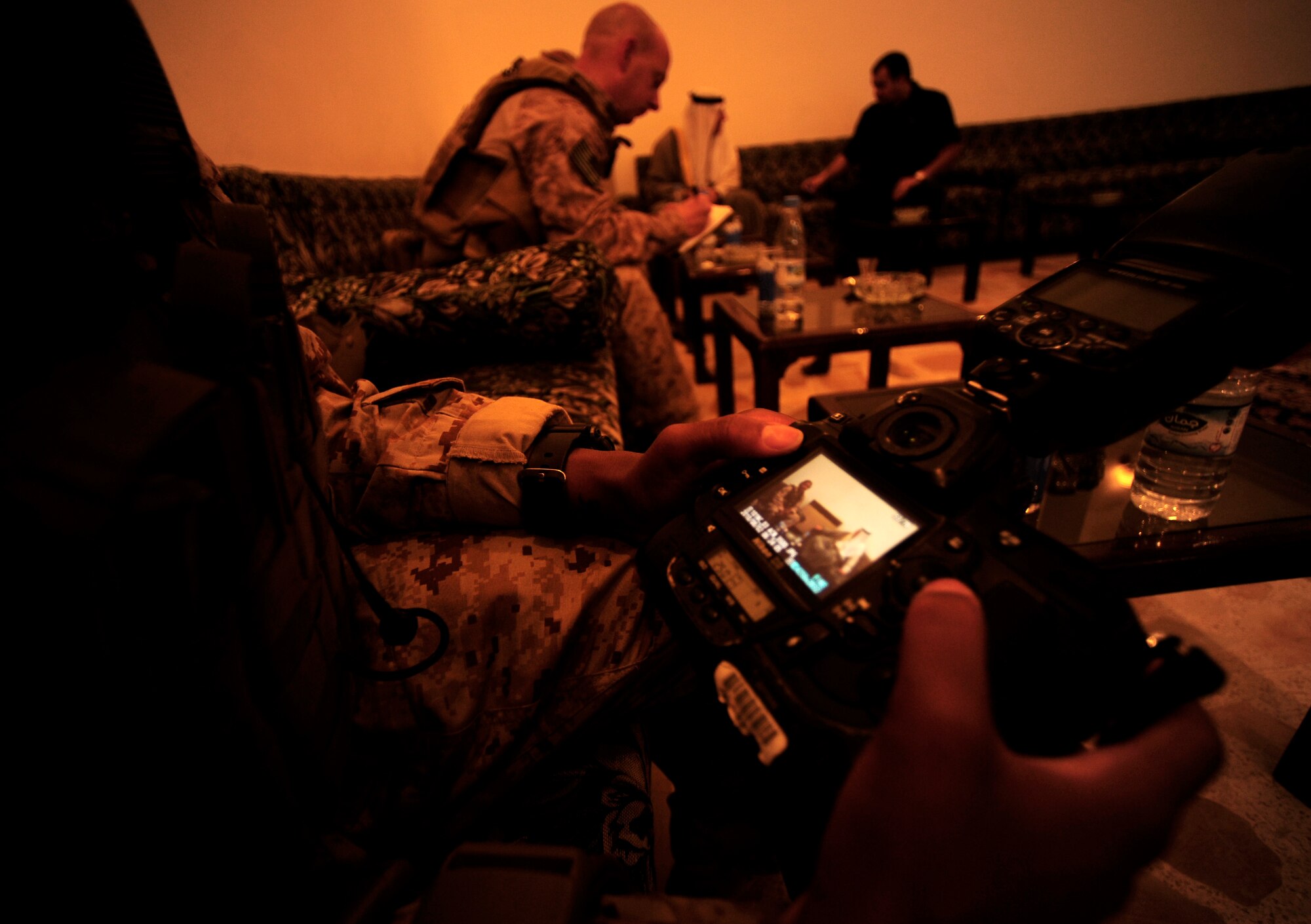 U.S. Air Force Senior Airman Asha McMakin, a combat photographer assigned to the 1st Combat Camera Squadron, examines her imagery during a key leader engagement meet at Ramadi, Iraq on Aug. 2, 2010. SrA McMakin is attached to an Army Civil Affairs team while deployed in support of Operation Iraqi Freedom.
(U.S. Air Force photo by Staff Sgt. Andy M. Kin / Released)