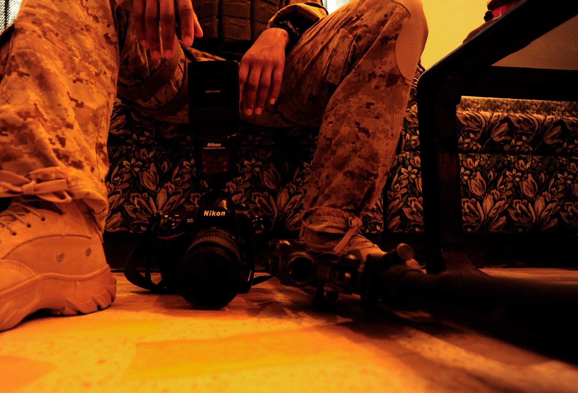 U.S. Air Force Senior Airman Asha McMakin, a combat photographer assigned to the 1st Combat Camera Squadron, sits her camera and M4 Rifle down while sitting in on a key leader engagement meeting in Ramadi, Iraq on Aug. 2, 2010.  SrA McMakin is attached to an Army Civil Affairs team while deployed in support of Operation Iraqi Freedom.
 (U.S. Air Force photo by Staff Sgt. Andy M. Kin / Released)
