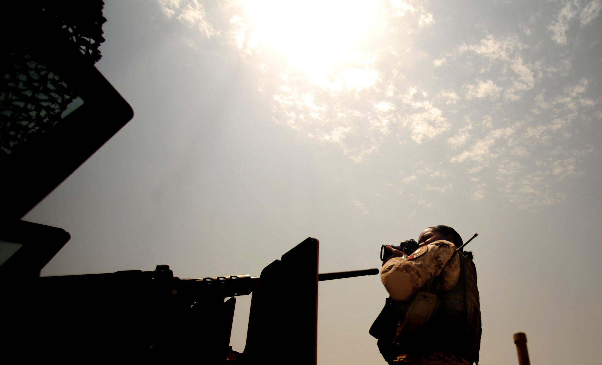 U.S. Air Force Senior Airman Asha McMakin, a combat photographer assigned to the 1st Combat Camera Squadron, shoots a photo of the gunner on top of a High Mobility Multipurpose Wheeled Vehicle (HMMWV) while documenting team members who are prepping for key leader engagement mission at Ramadi, Iraq on Aug. 2, 2010. SrA McMakin is attached to an Army Civil Affairs team while deployed in support of Operation Iraqi Freedom.
(U.S. Air Force photo by Staff Sgt. Andy M. Kin / Released)