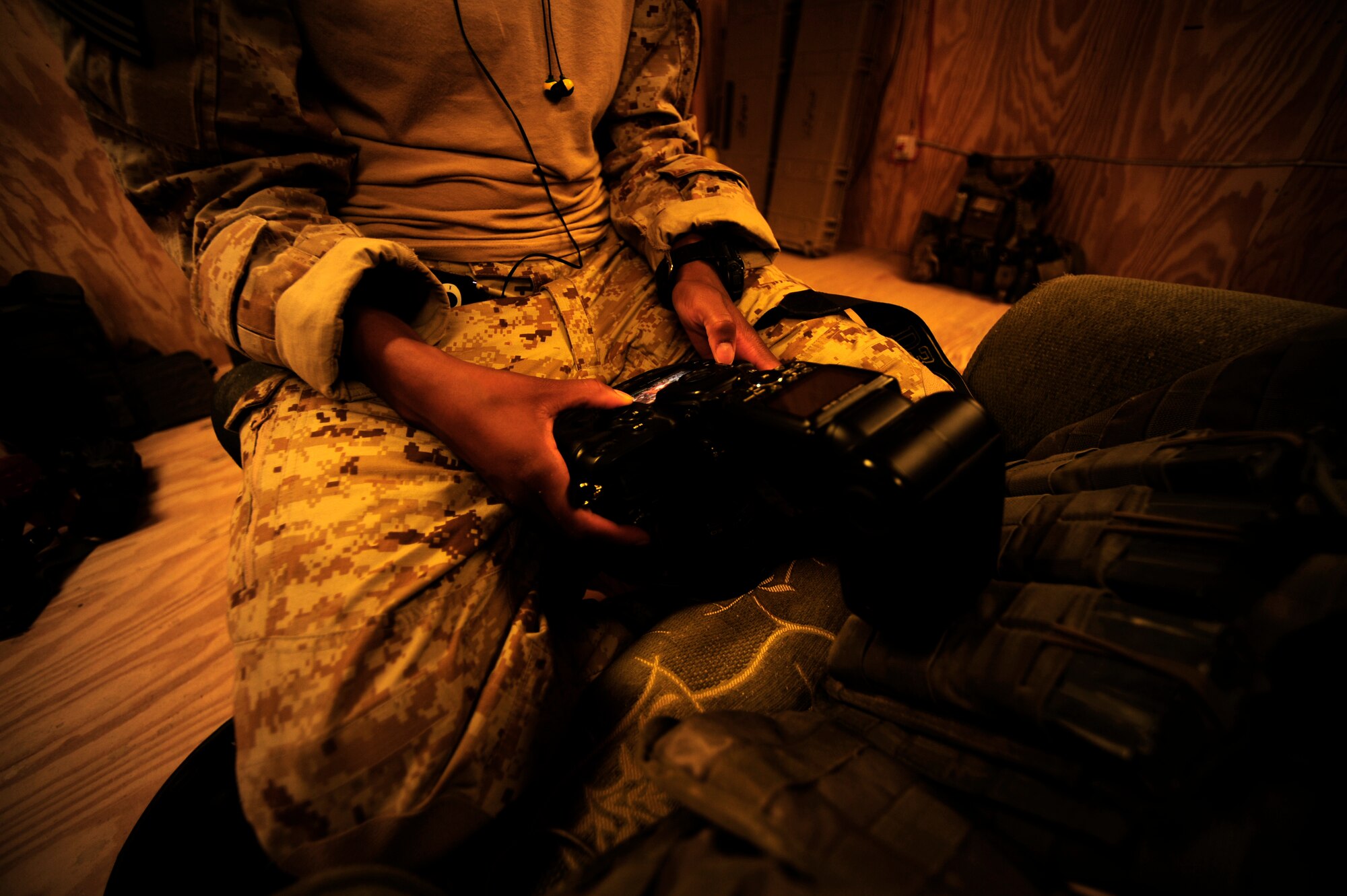 U.S. Air Force Senior Airman Asha McMakin, a combat photographer assigned to the 1st Combat Camera Squadron, preps her Nikon D3 camera prior to a key leader engagement mission in Ramadi, Iraq on Aug. 2, 2010.  SrA McMakin is attached to an Army Civil Affairs team while deployed in support of Operation Iraqi Freedom. 
(U.S. Air Force photo by Staff Sgt. Andy M. Kin / Released)