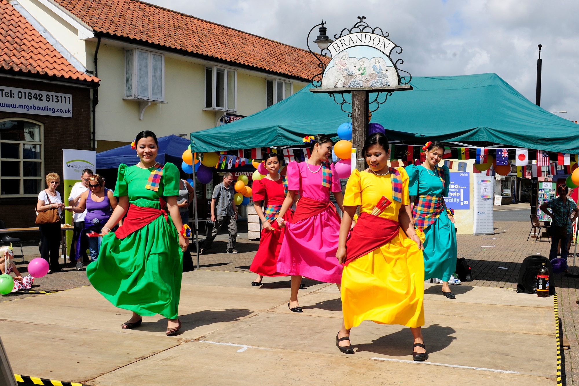 RAFs Lakenheath and Mildenhall’s Filipino-American Friendship Club dancers, perform at Market Hill in Brandon, England, Aug 7. The dance they are performing is called the Carinosa, which is a Spanish inspired traditional Filipino dance. (U.S. Air Force photo/Airman 1st Class Tiffany Deuel)