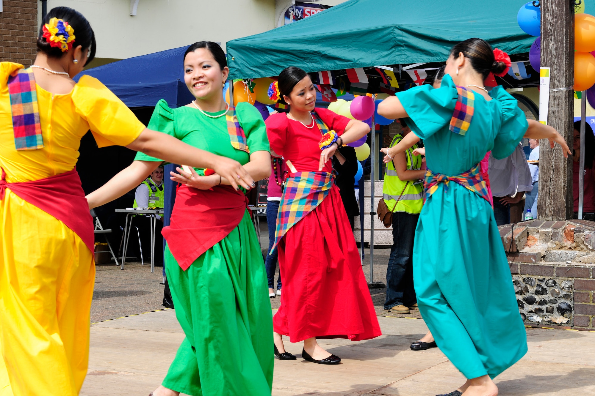 RAFs Lakenheath and Mildenhall’s Filipino-American Friendship Club dancers perform at Market Hill in Brandon, England, Aug 7. The Fil-Am has approximately 150 military members, not including dependants. (U.S. Air Force photo/Airman 1st Class Tiffany Deuel)