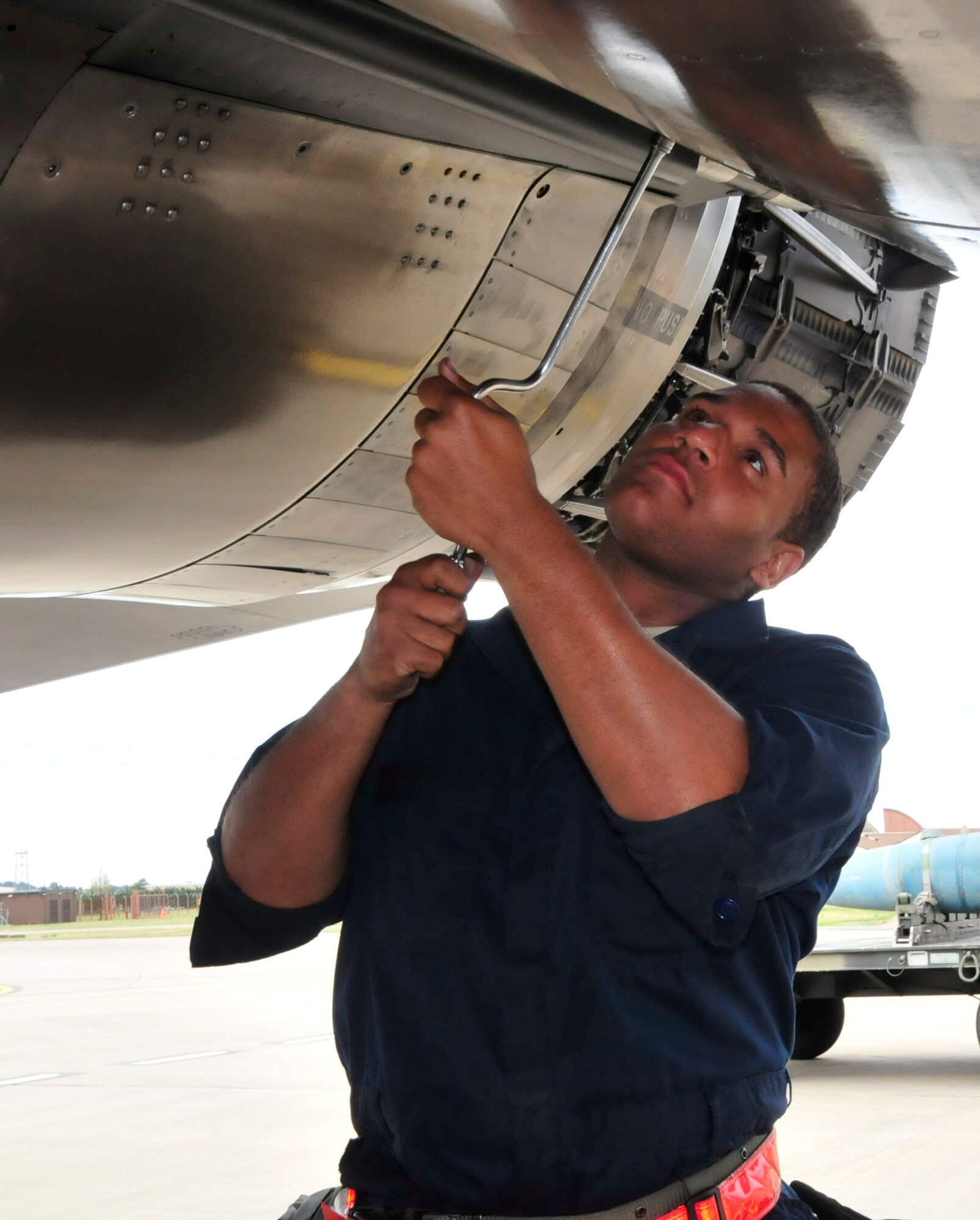 Airman 1st Class Dakota Curry, 494th Maintenance Unit crew chief, tightens panels on an F-15 during an operational readiness exercise at RAF Lakenheath, England, Aug. 11. (U.S. Air Force photo/ Airman 1st Class Eboni Knox)