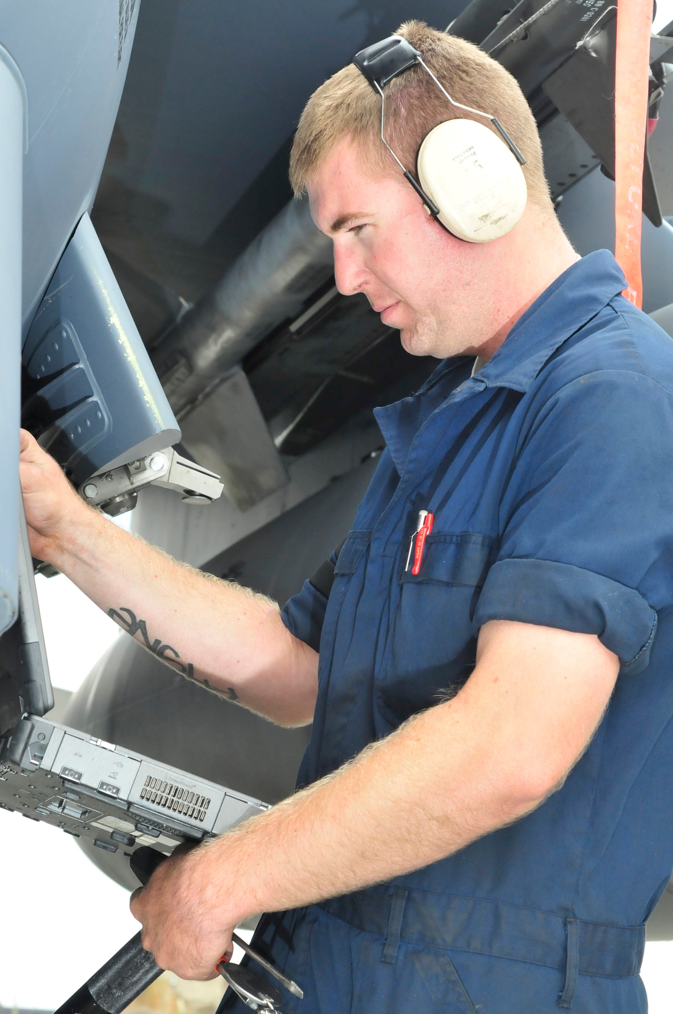 Senior Airman Michael Strombelline, 48th Aircraft Maintenance Squadron avionics specialist, checks the technical manual while running operations check on an F-15 at RAF Lakenheath, England, Aug. 11. Airman Strombelline is a player in a base wide operational readiness exercise. (U.S. Air Force photo/Airman 1st Class Eboni Knox)