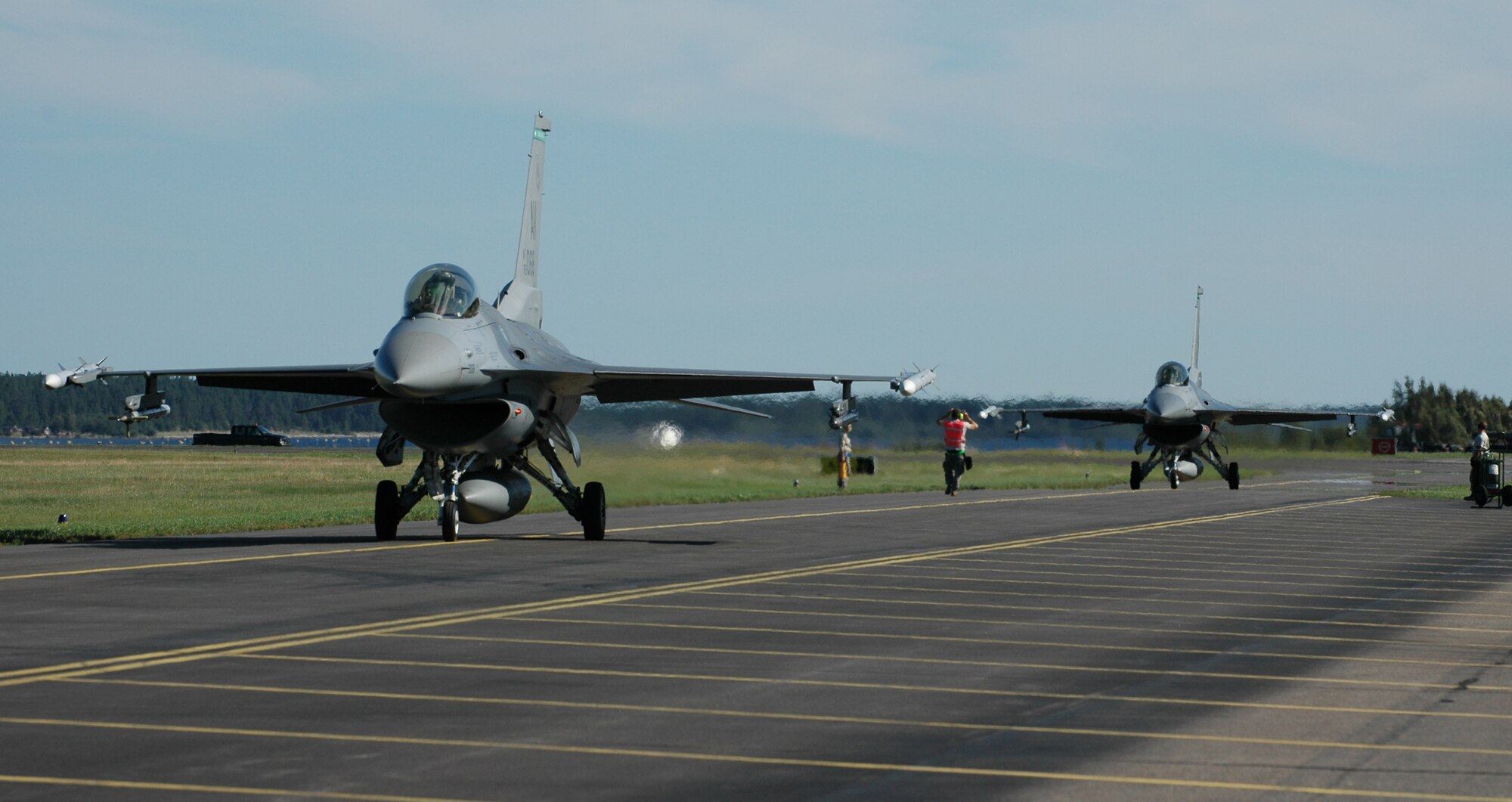 Two Aviano F-16s taxi down the runway after conducting an air-to-ground flying mission Aug. 5, 2010 at Kallax Air Base, Sweden. More than 250 Airmen from the 555th Fighter Squadron and 31st Aircraft Maintenance Squadron traveled to the Swedish air base on July 30, 2010 for a two week exercise conducting air-to-air and air-to-ground flying missions alongside the Swedish air force members assigned to Norrbotten Wing. (U.S. Air Force photo by Tech. Sgt. Lindsey Maurice/Released) 