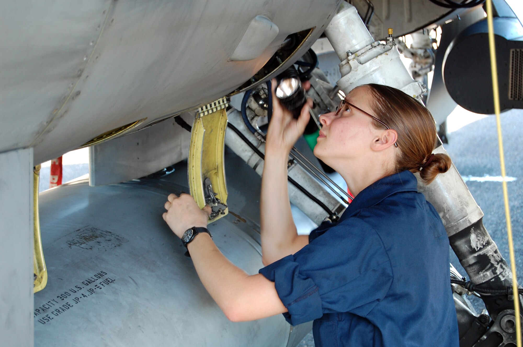 Airman 1st Class Kristin Frazier, 31st Aircraft Maintenance Squadron crew chief, conducts a post flight inspection on an F-16 Aug. 5, 2010 at Kallax Air Base, Sweden. The 555th Fighter Squadron and 31st AMXS conducted more than 180 air-to-air and air-to-ground missions during a two week exercise at the air base in which they worked alongside the Swedish air force's Norrbotten Wing. (U.S. Air Force photo by Tech. Sgt. Lindsey Maurice/Released)