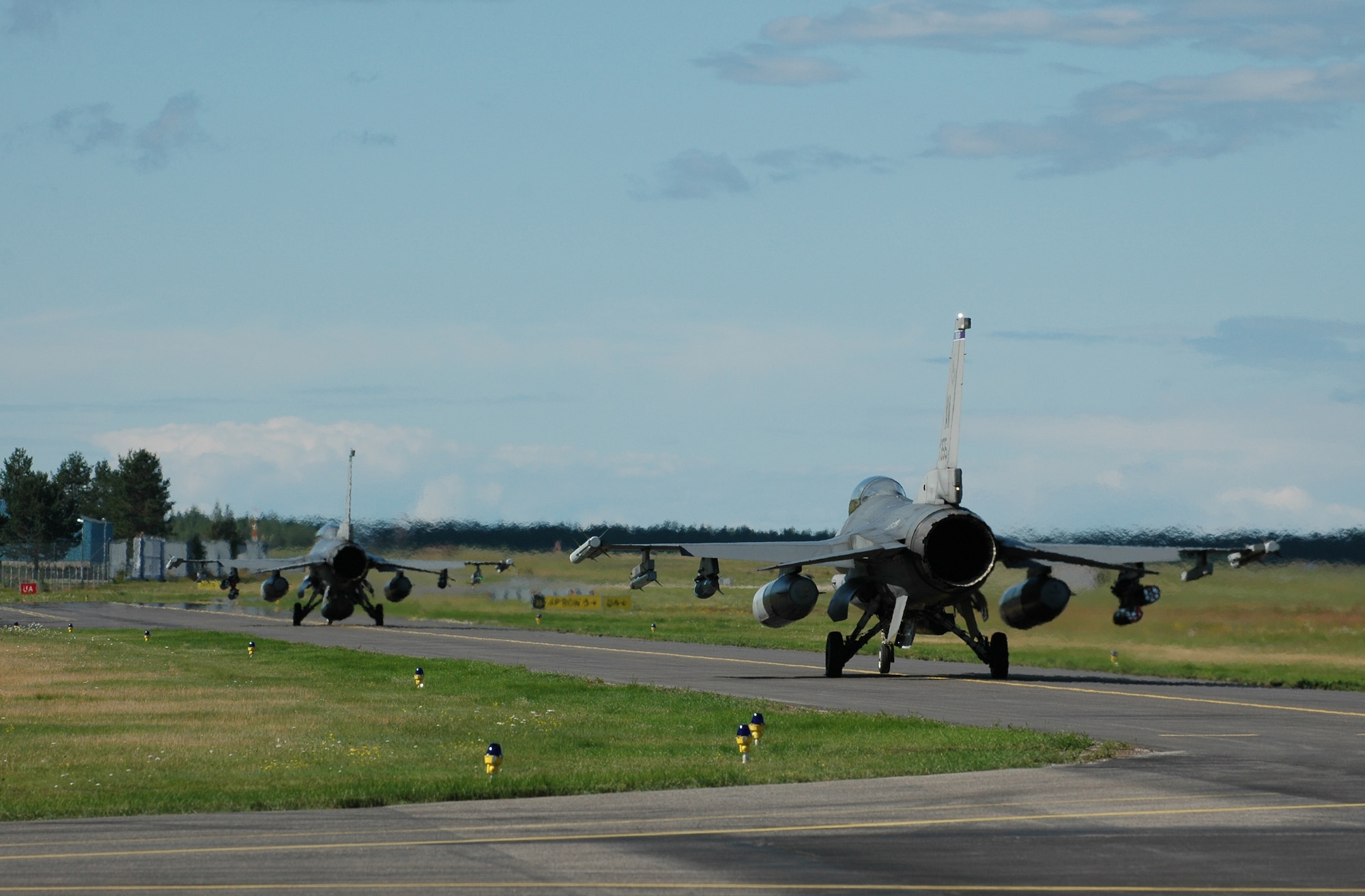 Two F-16s taxi out onto the runway for an air-to-ground training mission Aug. 5, 2010 at Kallax Air Base, Sweden. More than 250 men and women from the 555th Fighter Squadron and 31st Aircraft Maintenance Squadron traveled to the Swedish air base on July 30, 2010 for a two week exercise conducting air-to-air and air-to-ground flying missions with Norrbotten Wing. (U.S. Air Force photo by Tech. Sgt. Lindsey Maurice/Released)