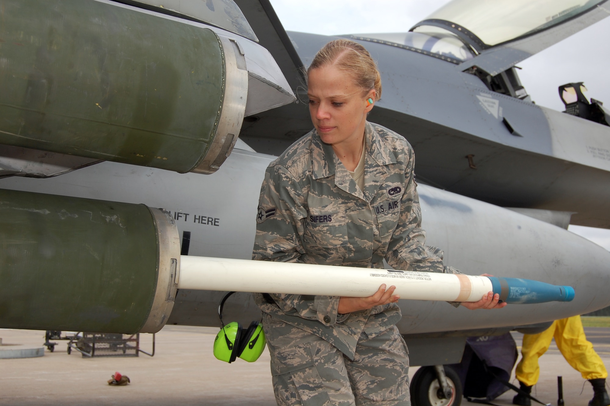 Airman 1st Class Kelly Sifers, 31st Aircraft Maintenance Squadron weapons load crew member, loads a practice rocket onto an F-16 during a training exercise Aug. 4, 2010 at Kallax Air Base, Sweden. The 555th Fighter Squadron and 31st AMXS conducted more than 180 air-to-air and air-to-ground missions during a two week exercise at the air base in which they worked alongside the Swedish air force's Norrbotten Wing. (U.S. Air Force photo by Tech. Sgt. Lindsey Maurice/Released)