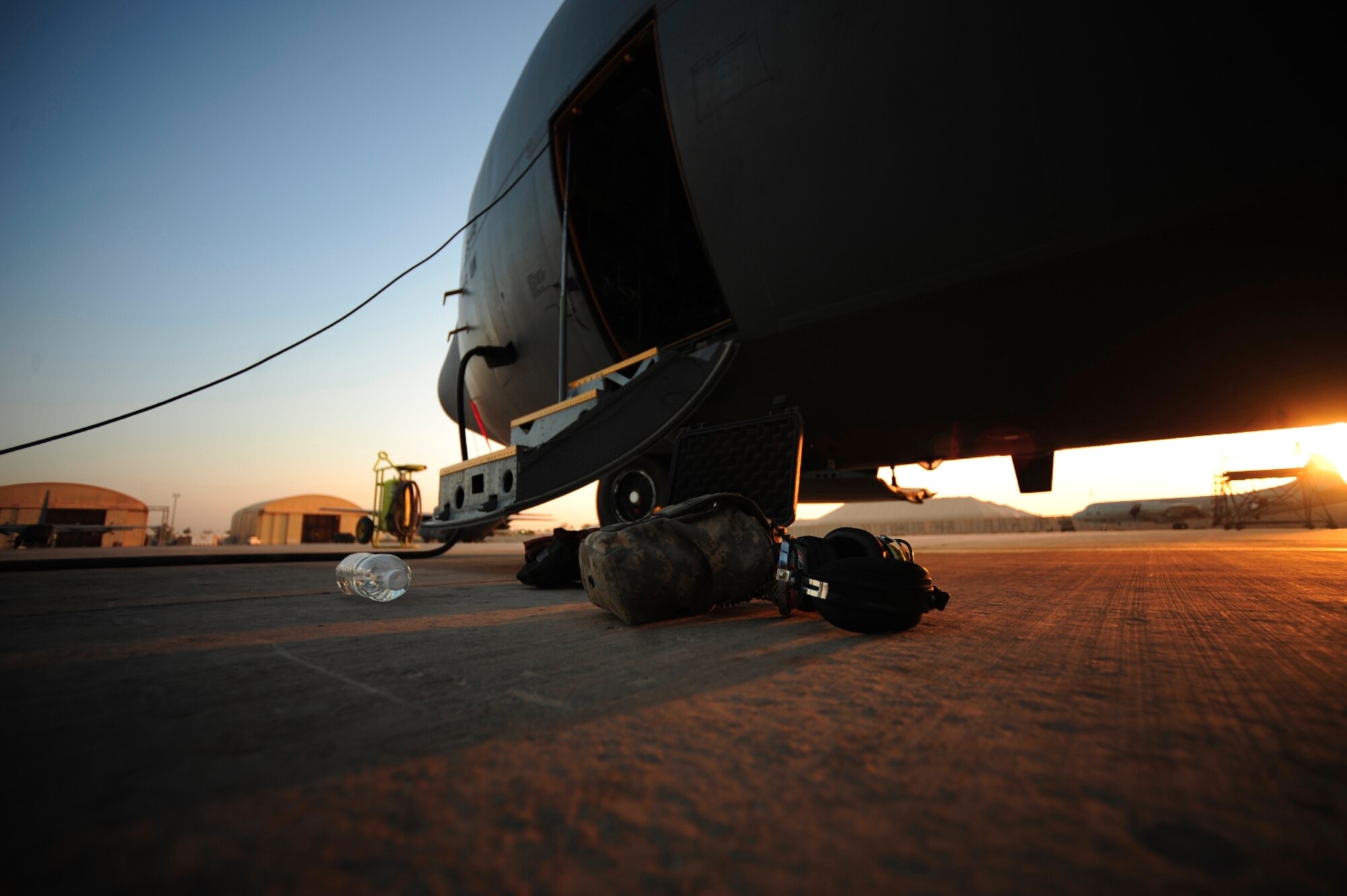 U.S. Air Force maintenance crew assigned to the 777th Expeditionary Aircraft Maintenance Squadron, gear sits next to a C-130 Hercules aircraft crew entry door during pre-flight inspections at Joint Base Balad, Iraq on July 25, 2010. (U.S. Air Force photo by Staff Sgt. Andy M. Kin / Released)