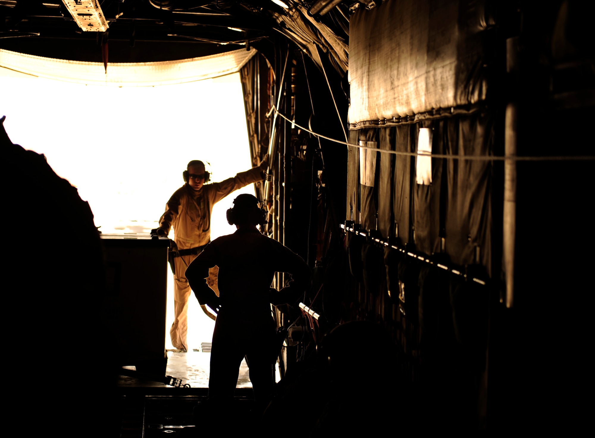 U.S. Air Force Staff Sgts. Jeffrey Skipper and Karen Hunt, C-130 Hercules loadmasters assigned to the 777th Expeditionary Airlift Squadron, over watch heavy cargo on load at Al Asad, Iraq during a flying mission from Joint Base Balad, Iraq on July 25, 2010. 
(U.S. Air Force photo by Staff Sgt. Andy M. Kin / Released)