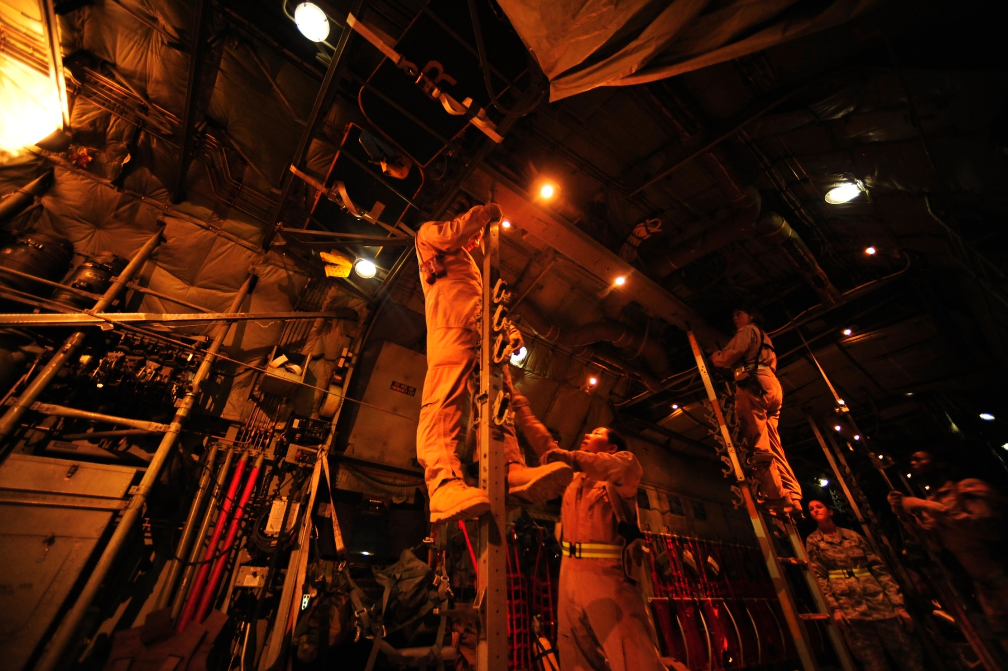 Crew members assigned to the 362nd Expeditionary Aeromedical Evacuation Flight, configure a C-130 Hercules aircraft for an aeromedical evacuation mission during pre-flight inspections at Joint Base Balad, Iraq on July 17, 2010. (U.S. Air Force photo by Staff Sgt. Andy M. Kin / Released)