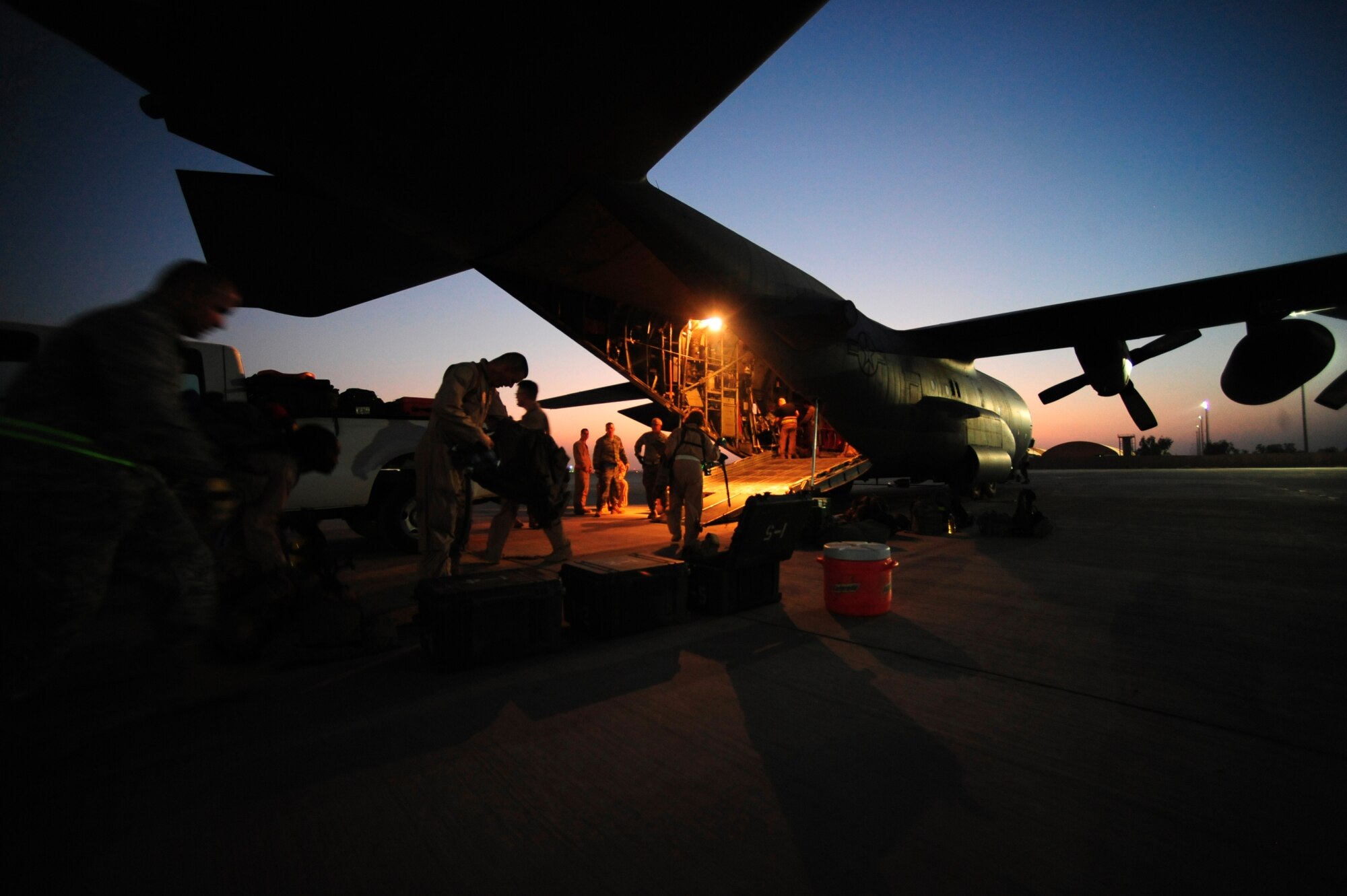 U.S. Air Force airmen of the 362nd Expeditionary Aeromedical Evacuation Flight, load a C-130 Hercules aircraft with all their medical gear for a aeromedical evacuation mission at Joint Base Balad, Iraq on July 17, 2010. (U.S. Air Force photo by Staff Sgt. Andy M. Kin / Released)