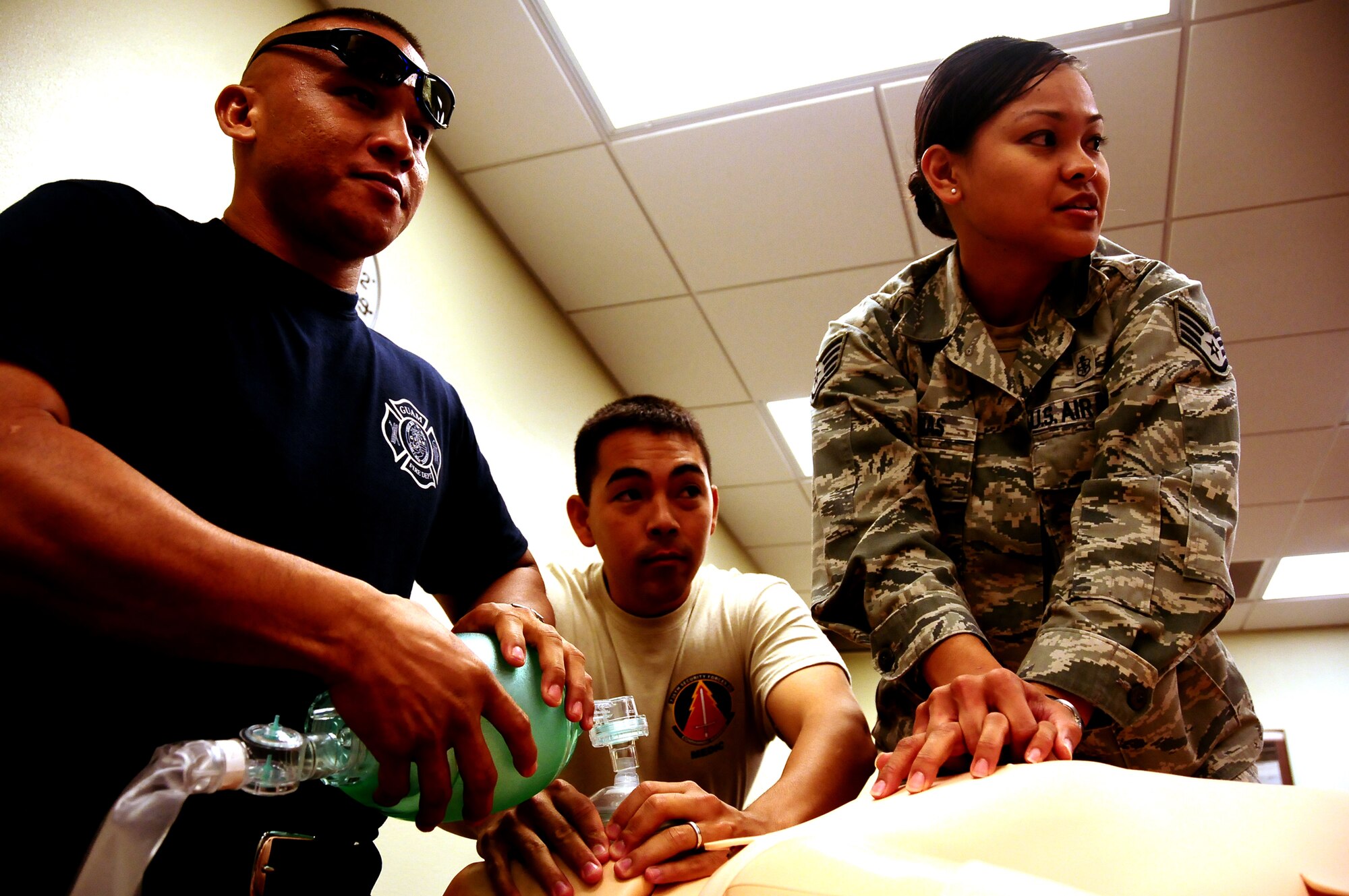 ANDERSEN AIR FORCE BASE, Guam – Army National Guard Sgt. Joe Sablan, Guam Fire Deptarment, Staff Sgt. Jon-Jay Sabati and Staff Sgt. Tiana Duenas  , 736th Security Forces Squadron Commando Warrior Pacific Air Forces Regional Training Center, administer first-aid on a SimMan 3G mannequin Aug. 5, at the Commando Warrior Regional Training Center. SimMan 3G, a realistic human patient simulator created by a major medical equipment manufacturer,  is designed to provide a more hands on training experience for emergency responders and medics. The 736th SFS’s Commando Warrior Pacific Air Forces Regional Training Center now possesses two. (U.S. Air Force photo by Airman 1st Class Anthony Jennings)