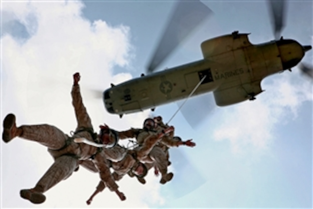 U.S. Marines attending the Helicopter Rope Suspension Techniques Masters Course perform Special Patrol Insertion/Extraction from a CH-46E Sea Knight helicopter at the Central Training Area on Camp Hanson, Okinawa, Japan, Aug. 4, 2010.