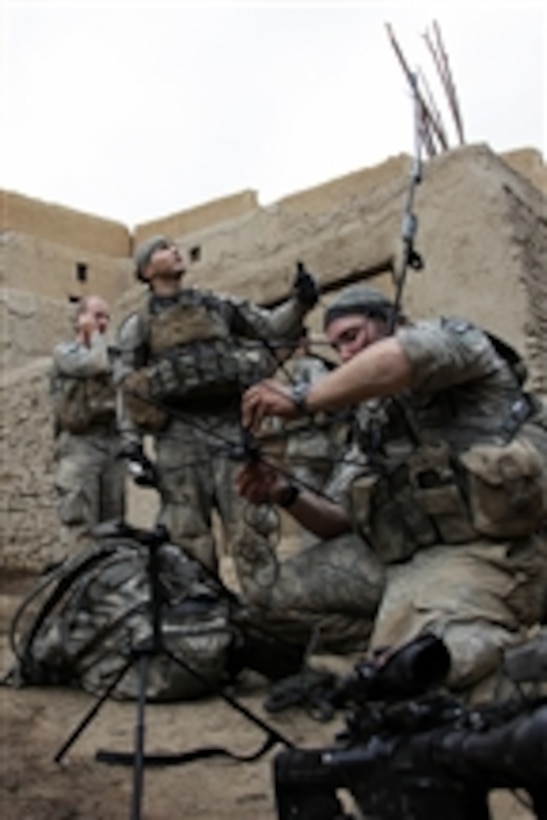 U.S. Army soldiers with 2nd Platoon, Attack Company, 1st Regiment, 503rd Infantry Battalion, 173rd Airborne Brigade Combat Team set up a tactical satellite communication system in Shekhabad Valley, Wardak province, Afghanistan, on Aug. 9, 2010.  