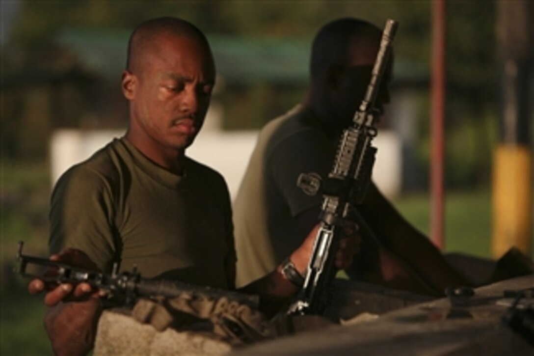 A U.S. Marine sergeant with 3rd Assault Amphibian Battalion cleans his gear after a day of jungle warfare training at Bahia Malaga Naval Base, Colombia, on Aug. 4, 2010.  The unit is deployed to support operation Partnership of the Americas/Southern Exchange 2010, a combined amphibious exercise designed to enhance cooperative partnerships with maritime forces from nine other nations.  